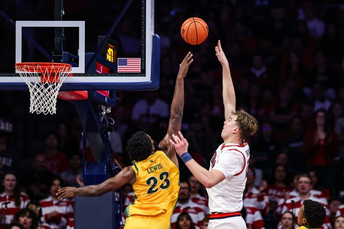 Nov 29, 2025; Tucson, Arizona, USA; Arizona Wildcats center Motiejus Krivas (13) makes a lay up over Norfolk State Spartans forward Keyontae Lewis (23) during the first half at McKale Memorial Center. Mandatory Credit: Aryanna Frank-Imagn Images