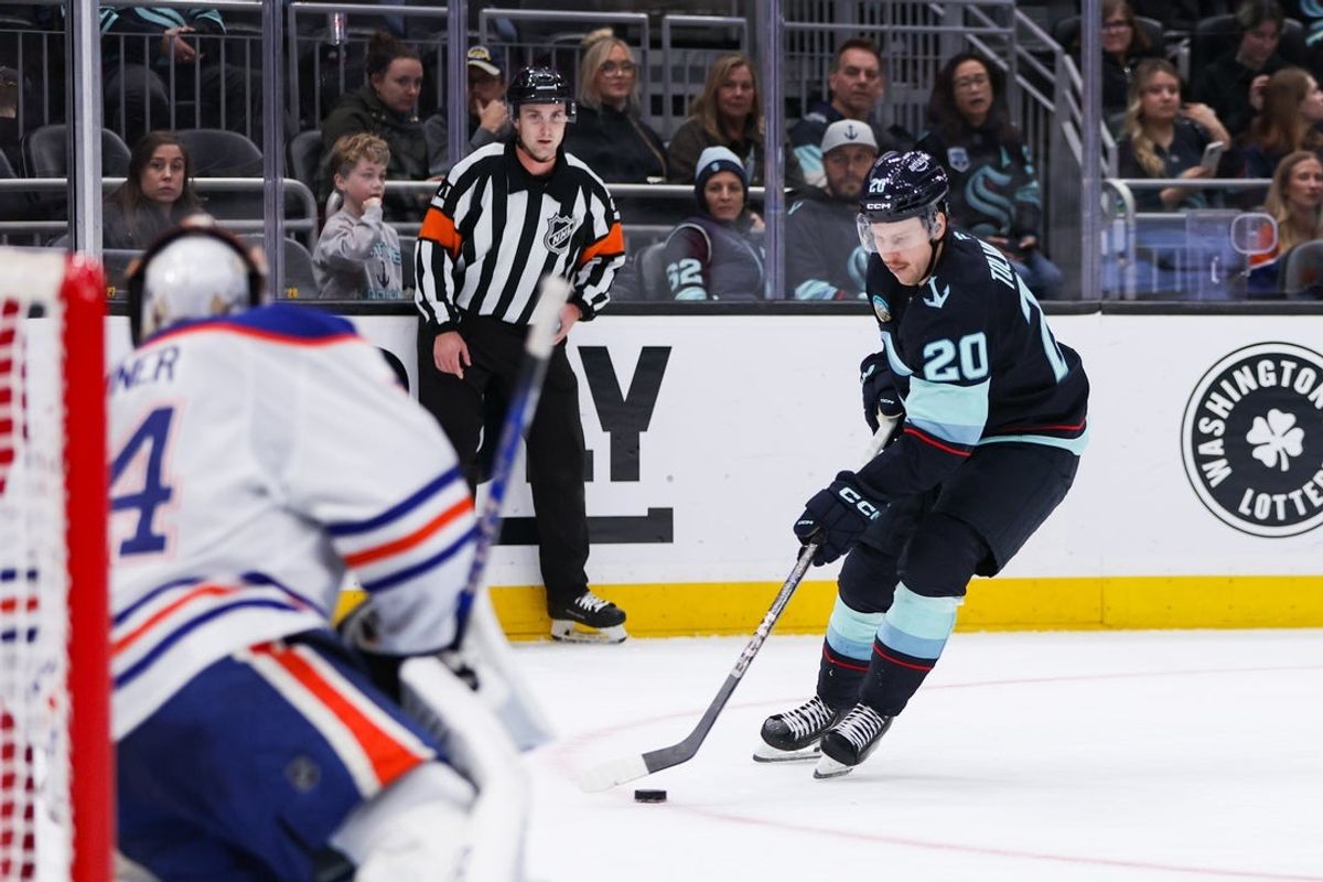 Nov 29, 2025; Seattle, Washington, USA; Seattle Kraken right wing Eeli Tolvanen (20) attempts a shot on goal in the third period against the Edmonton Oilers at Climate Pledge Arena. Mandatory Credit: Kevin Ng-Imagn Images