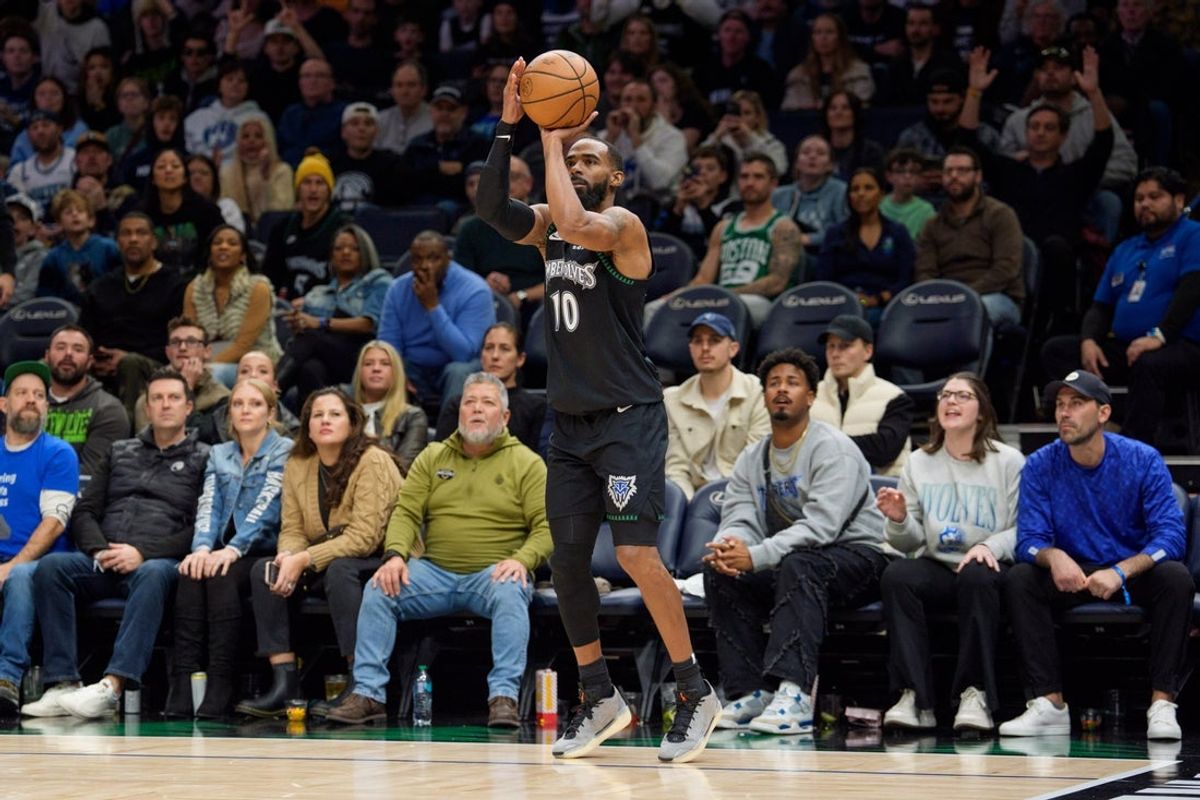 Nov 29, 2025; Minneapolis, Minnesota, USA; Minnesota Timberwolves guard Mike Conley (10) shoots a three pointer against the Boston Celtics in the fourth quarter at Target Center. Mandatory Credit: Matt Blewett-Imagn Images