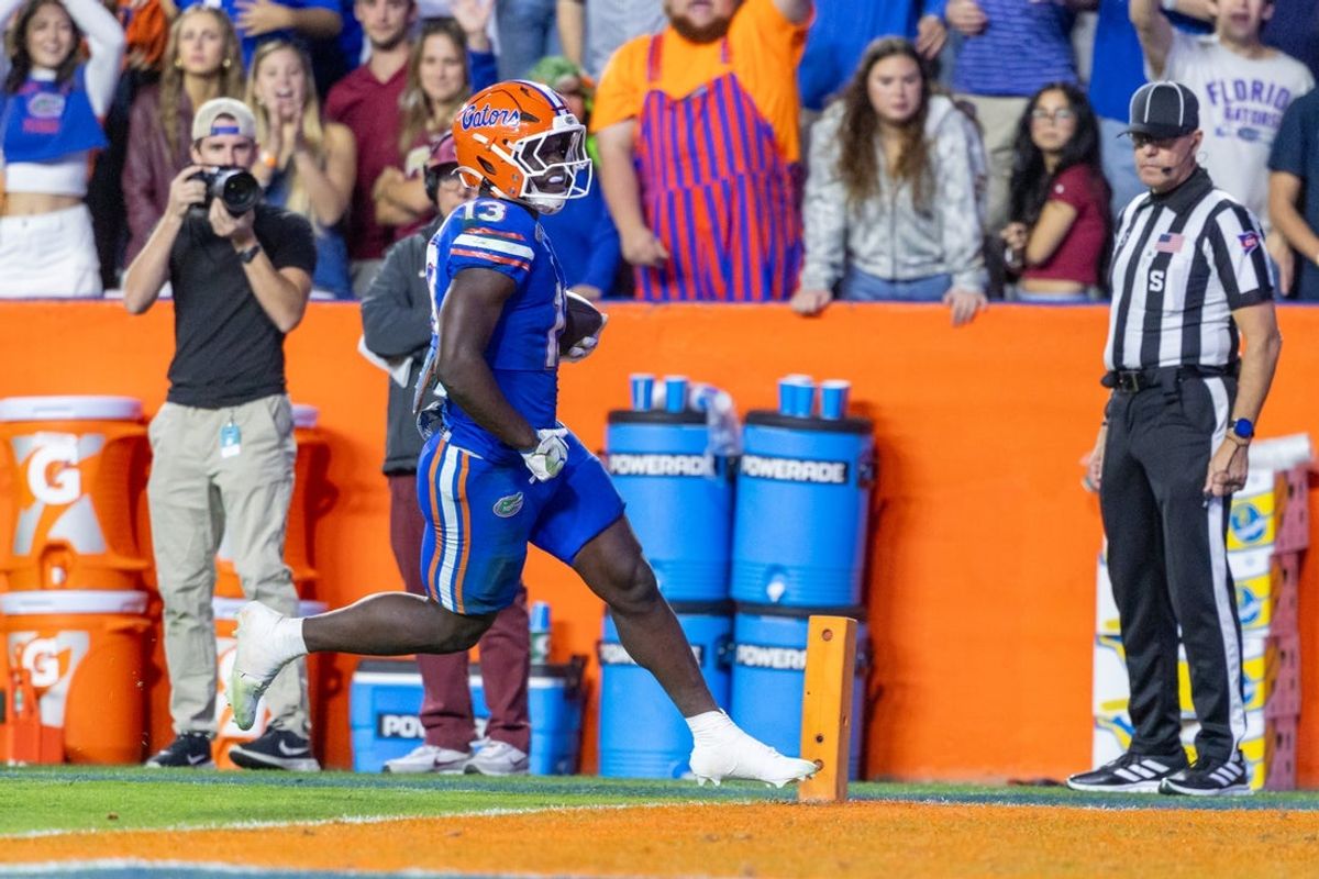 Nov 29, 2025; Gainesville, Florida, USA; Florida Gators running back Jadan Baugh (13) runs in for a touchdown during the third quarter against the Florida State Seminoles at Ben Hill Griffin Stadium. Mandatory Credit: Bob Kupbens-Imagn Images