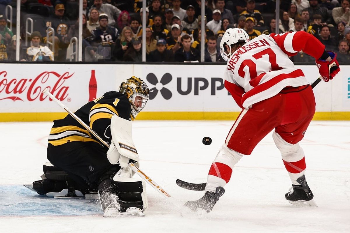 Nov 29, 2025; Boston, Massachusetts, USA; Detroit Red Wings center Michael Rasmussen (27) tries to control a loose puck in front of Boston Bruins goaltender Jeremy Swayman (1) during the second period at TD Garden. Mandatory Credit: Winslow Townson-Imagn Images