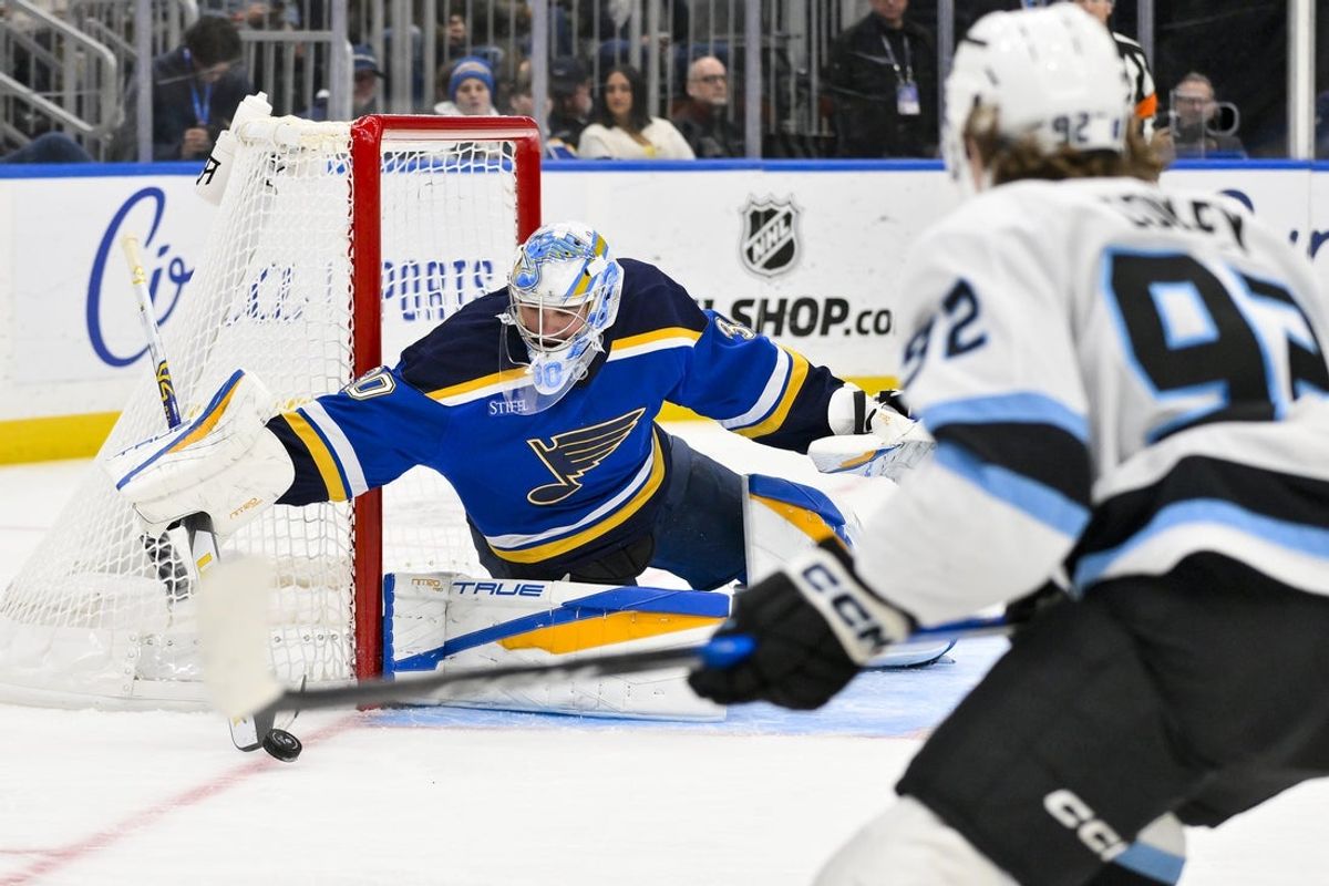 Nov 29, 2025; St. Louis, Missouri, USA; St. Louis Blues goaltender Joel Hofer (30) defends the net against Utah Mammoth center Logan Cooley (92) during the first period at Enterprise Center. Mandatory Credit: Jeff Curry-Imagn Images