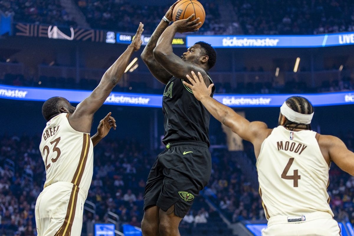 Nov 29, 2025; San Francisco, California, USA;  New Orleans Pelicans forward Zion Williamson (1) is defended by Golden State Warriors forward Draymond Green (23) and guard Moses Moody (4) during the first quarter at Chase Center. Mandatory Credit: John Hefti-Imagn Images