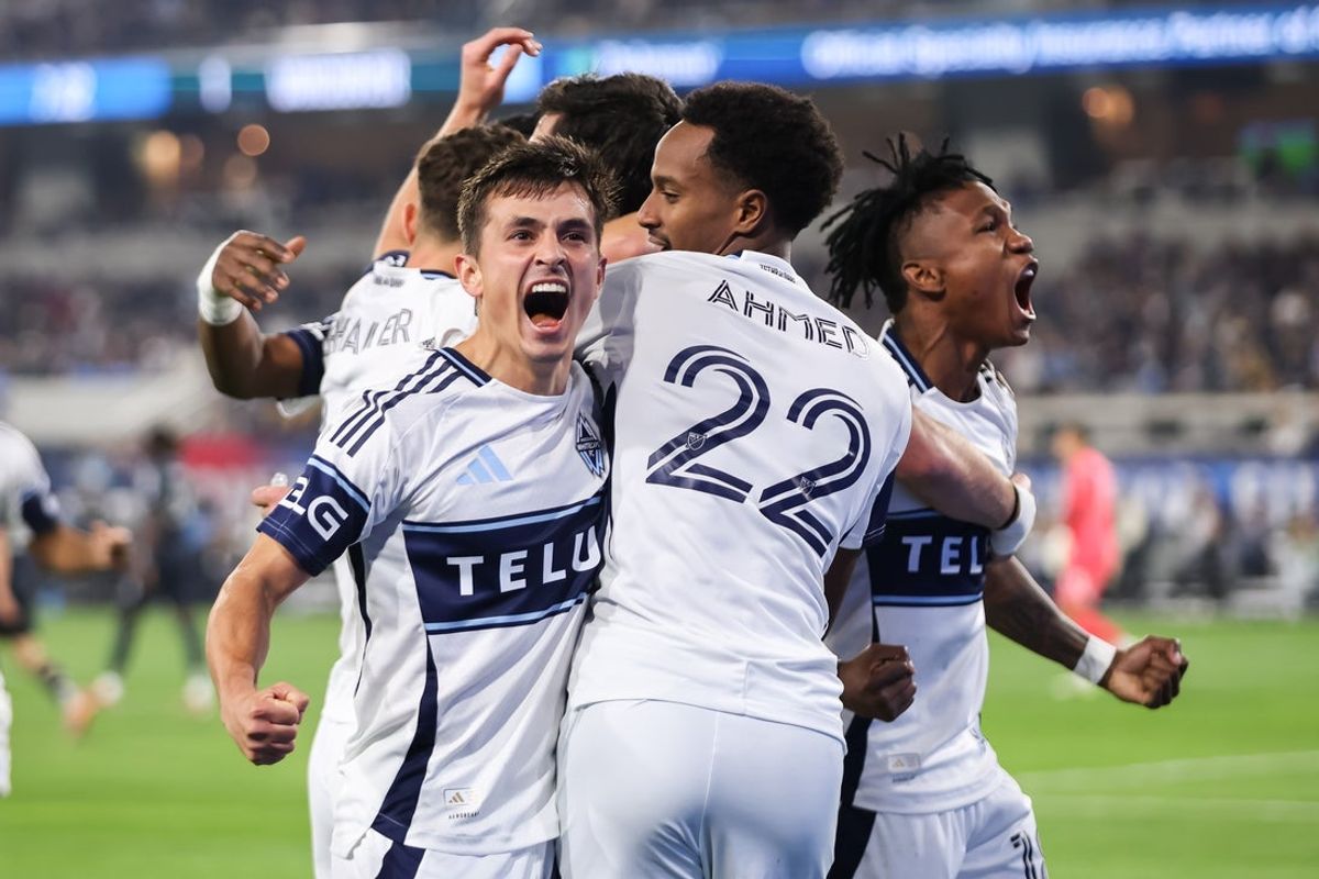 Nov 29, 2025; San Diego, California, USA; Vancouver Whitecaps midfielder Andres Cubas (20) celebrates a first half goal from forward Brian White (24) against San Diego FC at Snapdragon Stadium. Mandatory Credit: Chadd Cady-Imagn Images