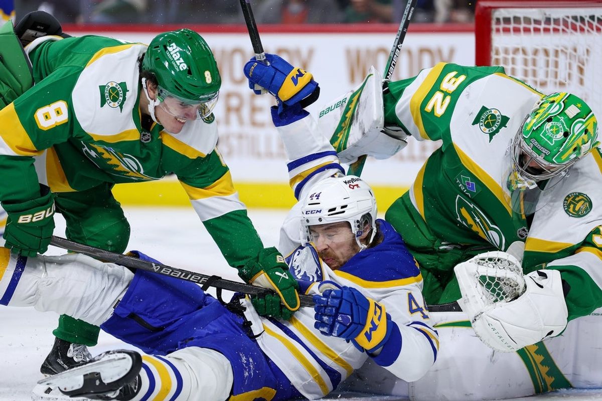 Nov 29, 2025; Saint Paul, Minnesota, USA; Minnesota Wild defenseman Zeev Buium (8) checks Buffalo Sabres center Josh Dunne (44) during the second period at Grand Casino Arena. Mandatory Credit: Matt Krohn-Imagn Images