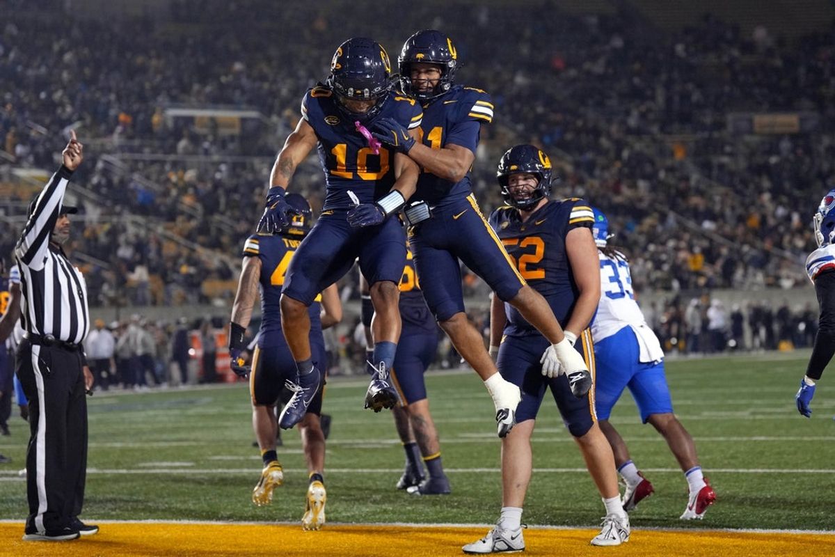 Nov 29, 2025; Berkeley, California, USA; California Golden Bears wide receiver Jacob De Jesus (center right) celebrates with wide receiver Jayden Dixon-Veal (center left) after scoring a touchdown against the Southern Methodist Mustangs during the second quarter at California Memorial Stadium. Mandatory Credit: Darren Yamashita-Imagn Images