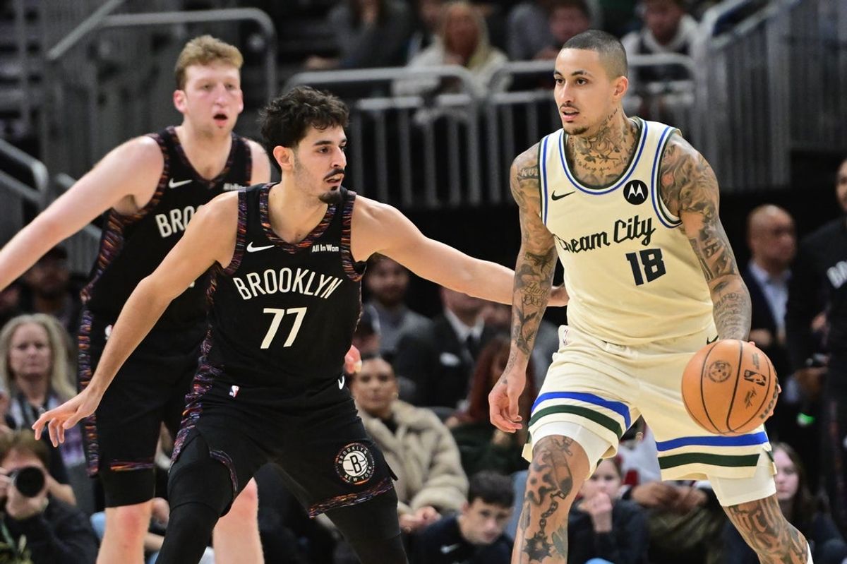 Nov 29, 2025; Milwaukee, Wisconsin, USA;  Milwaukee Bucks forward Kyle Kuzma (18) looks for a shot against Brooklyn Nets guard Ben Saraf (77) in the third quarter at Fiserv Forum. Mandatory Credit: Benny Sieu-Imagn Images