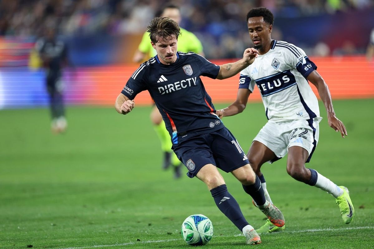Nov 29, 2025; San Diego, California, USA; San Diego FC forward Anders Dreyer (10) plays the ball against Vancouver Whitecaps midfielder Ali Ahmed (22) during the first half  at Snapdragon Stadium. Mandatory Credit: Abe Arredondo-Imagn Images