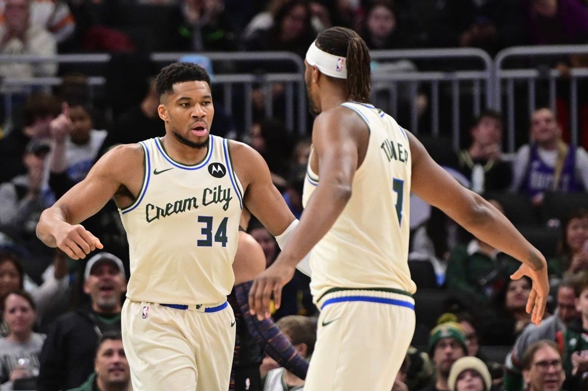 Nov 29, 2025; Milwaukee, Wisconsin, USA; Milwaukee Bucks forward Giannis Antetokounmpo (34) celebrates with guard Kevin Porter (7) after scoring a basket in the third quarter against the Brooklyn Nets at Fiserv Forum. Mandatory Credit: Benny Sieu-Imagn Images