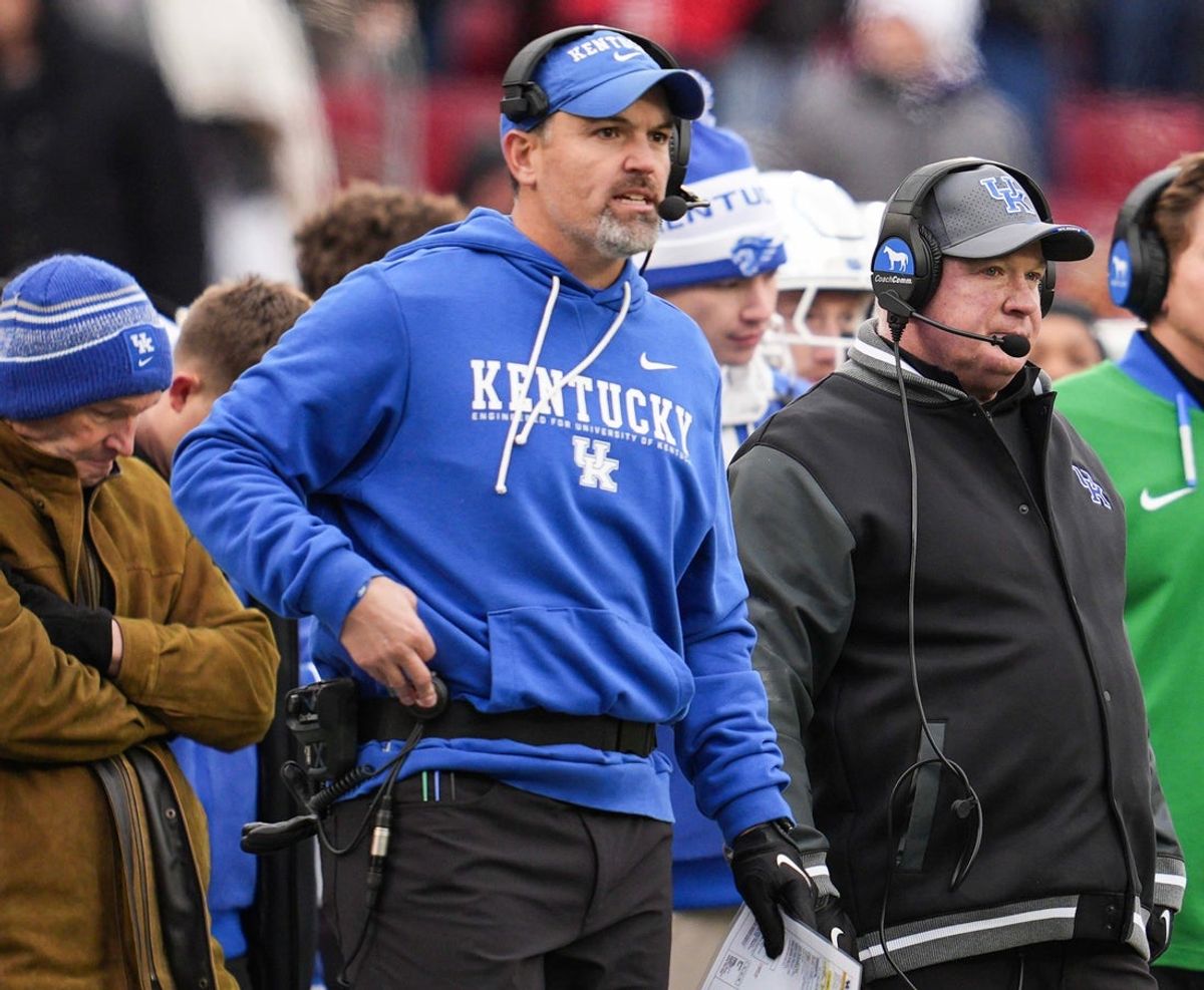 Kentucky defensive coordinator Brad White, center, and head football coach Mark Stoops, right, on the sidelines as UK athletic director Mitch Barnhart stands behind them at left during the loss against UofL Saturday, November 29, 2025 in Louisville, Kentucky at L&N Federal Credit Union Stadium. The Cats failed to score in the Cards' 41-0 of Kentucky.