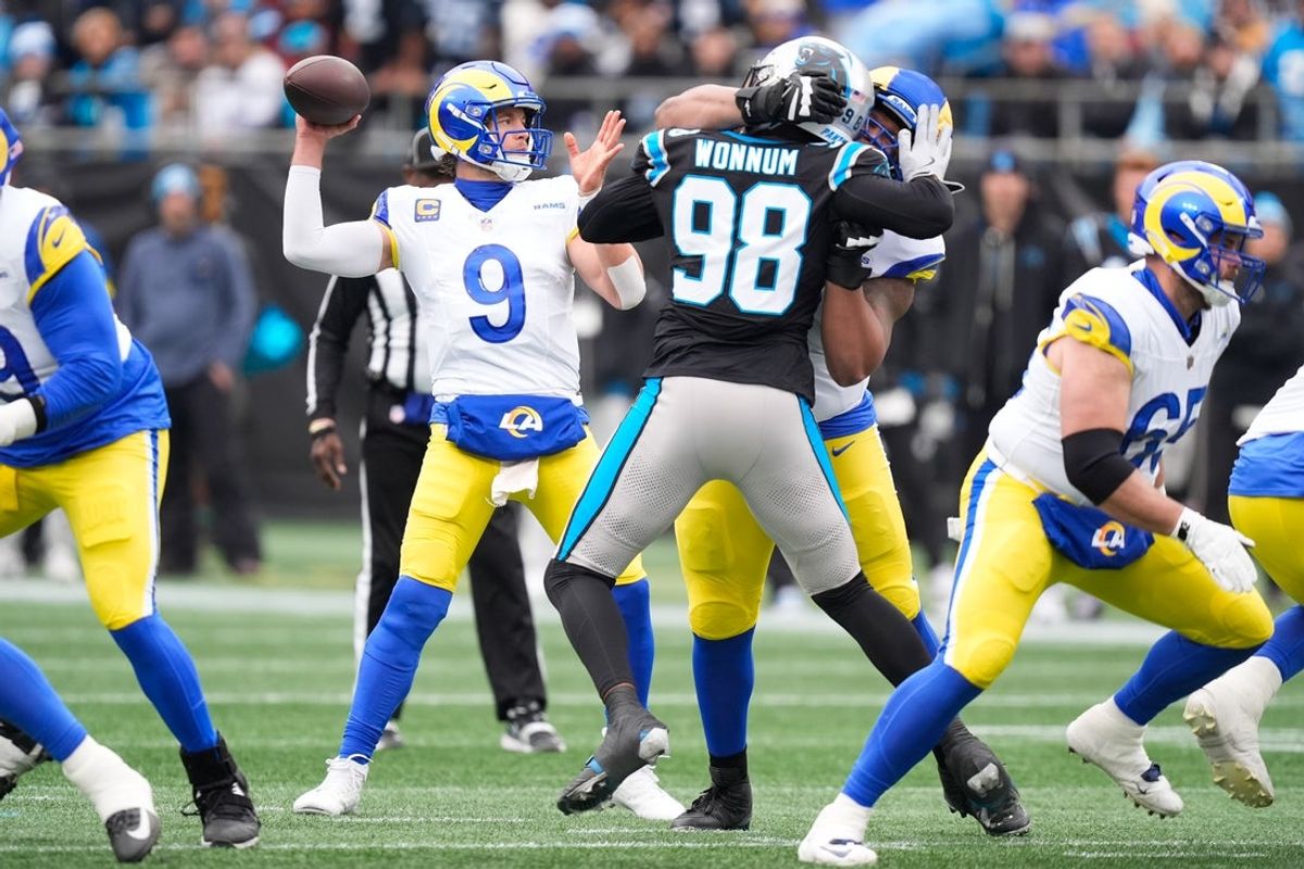 Nov 30, 2025; Charlotte, North Carolina, USA; Los Angeles Rams quarterback Matthew Stafford (9) throws a pass during the first quarter against the Carolina Panthers at Bank of America Stadium. Mandatory Credit: Jim Dedmon-Imagn Images