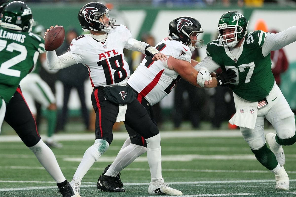 Nov 30, 2025; East Rutherford, New Jersey, USA;  Atlanta Falcons quarterback Kirk Cousins (18) drops back to pass against the New York Jets during the first half at MetLife Stadium. Mandatory Credit: Vincent Carchietta-Imagn Images