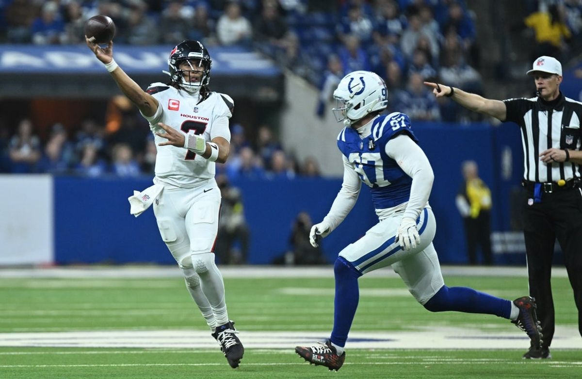 Nov 30, 2025; Indianapolis, Indiana, USA; Houston Texans quarterback C.J. Stroud (7) throws against Indianapolis Colts defensive end Laiatu Latu (97) during the second half at Lucas Oil Stadium. Mandatory Credit: Robert Goddin-Imagn Images