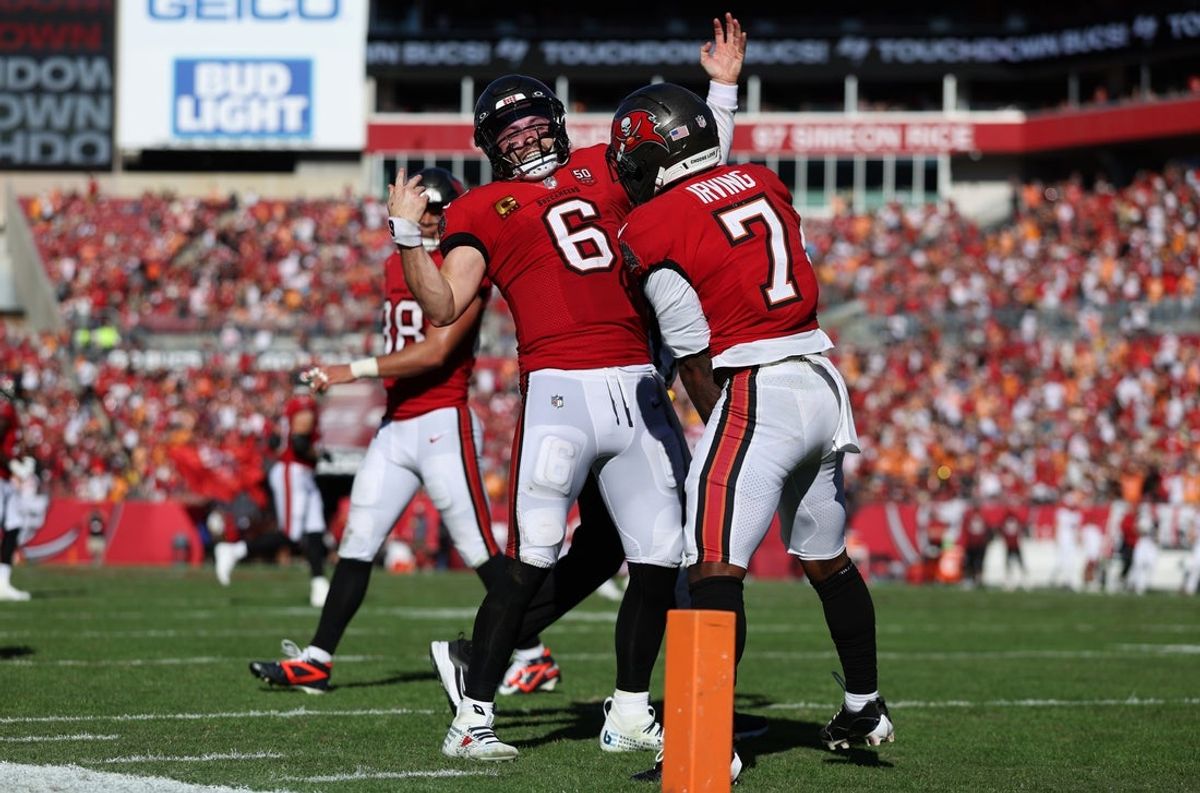 Nov 30, 2025; Tampa, Florida, USA; Tampa Bay Buccaneers running back Bucky Irving (7) celebrates with quarterback Baker Mayfield (6) after a touchdown during the second half against the Arizona Cardinals at Raymond James Stadium. Mandatory Credit: Nathan Ray Seebeck-Imagn Images