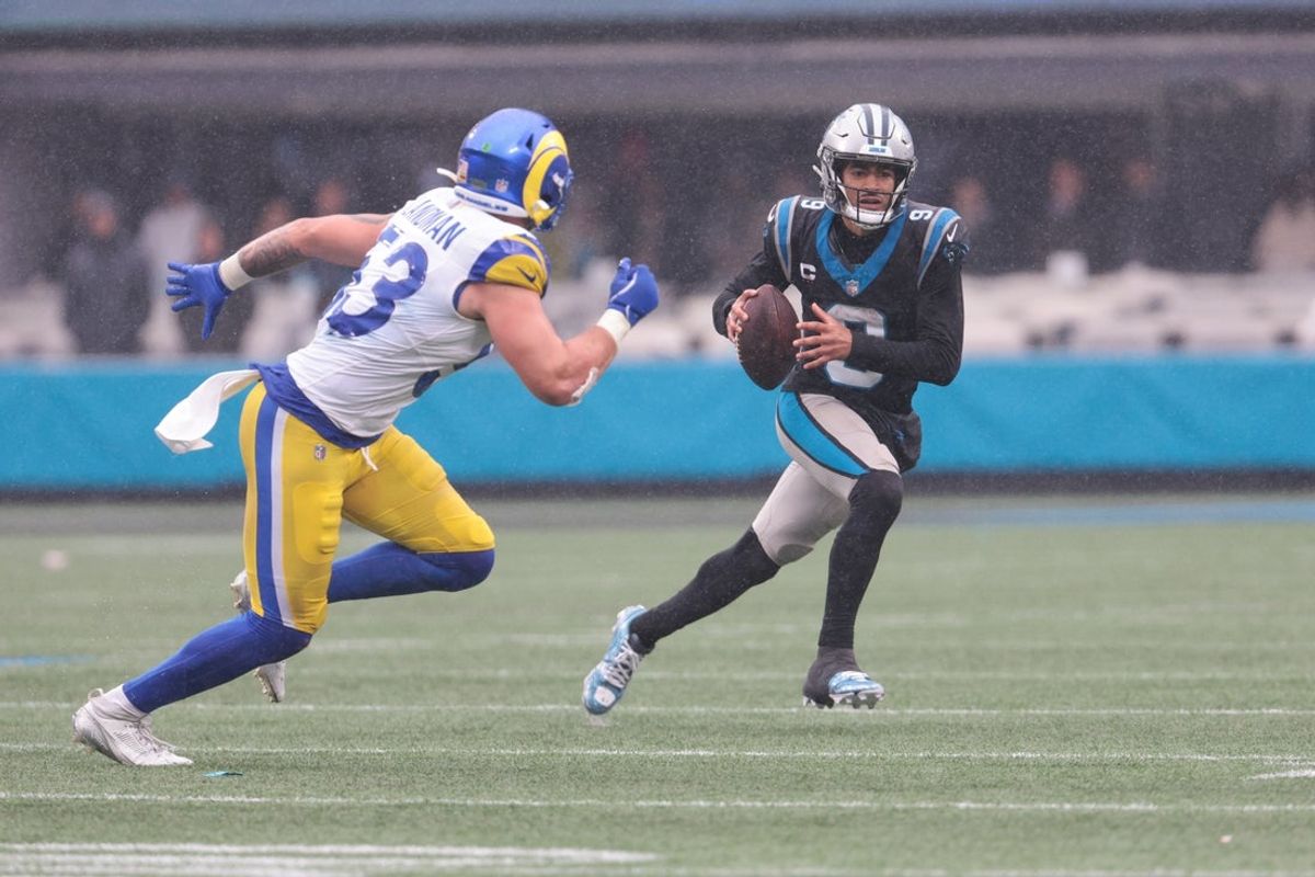 Nov 30, 2025; Charlotte, North Carolina, USA; Carolina Panthers quarterback Bryce Young (9) looks to pass as Los Angeles Rams linebacker Nate Landman (53) defends during the fourth quarter  at Bank of America Stadium. Mandatory Credit: Scott Kinser-Imagn Images