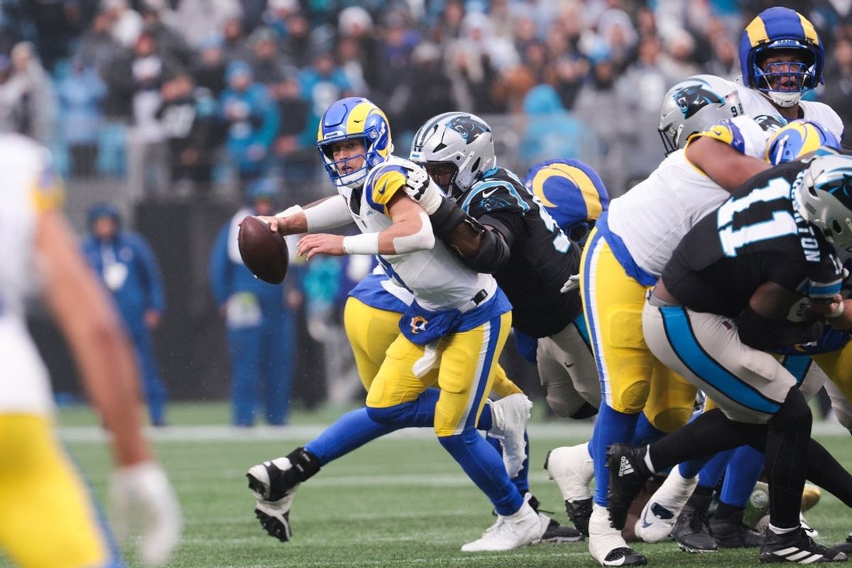 Nov 30, 2025; Charlotte, North Carolina, USA; Los Angeles Rams quarterback Matthew Stafford (9) is sacked by Carolina Panthers defensive end Derrick Brown (95) during the fourth quarter at Bank of America Stadium. Mandatory Credit: Scott Kinser-Imagn Images