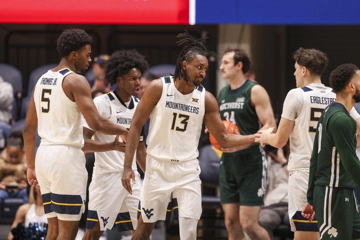 Nov 30, 2025; Morgantown, West Virginia, USA; West Virginia Mountaineers guard Chance Moore (13) celebrates with teammates after a play during the first half against the Mercyhurst Lakers at Hope Coliseum. Mandatory Credit: Ben Queen-Imagn Images