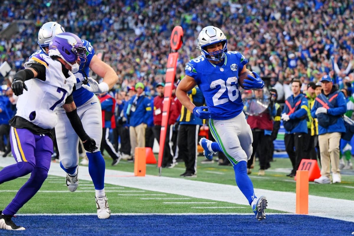 Nov 30, 2025; Seattle, Washington, USA; Seattle Seahawks running back Zach Charbonnet (26) scores a touchdown during the second half against the Minnesota Vikings at Lumen Field. Mandatory Credit: Steven Bisig-Imagn Images