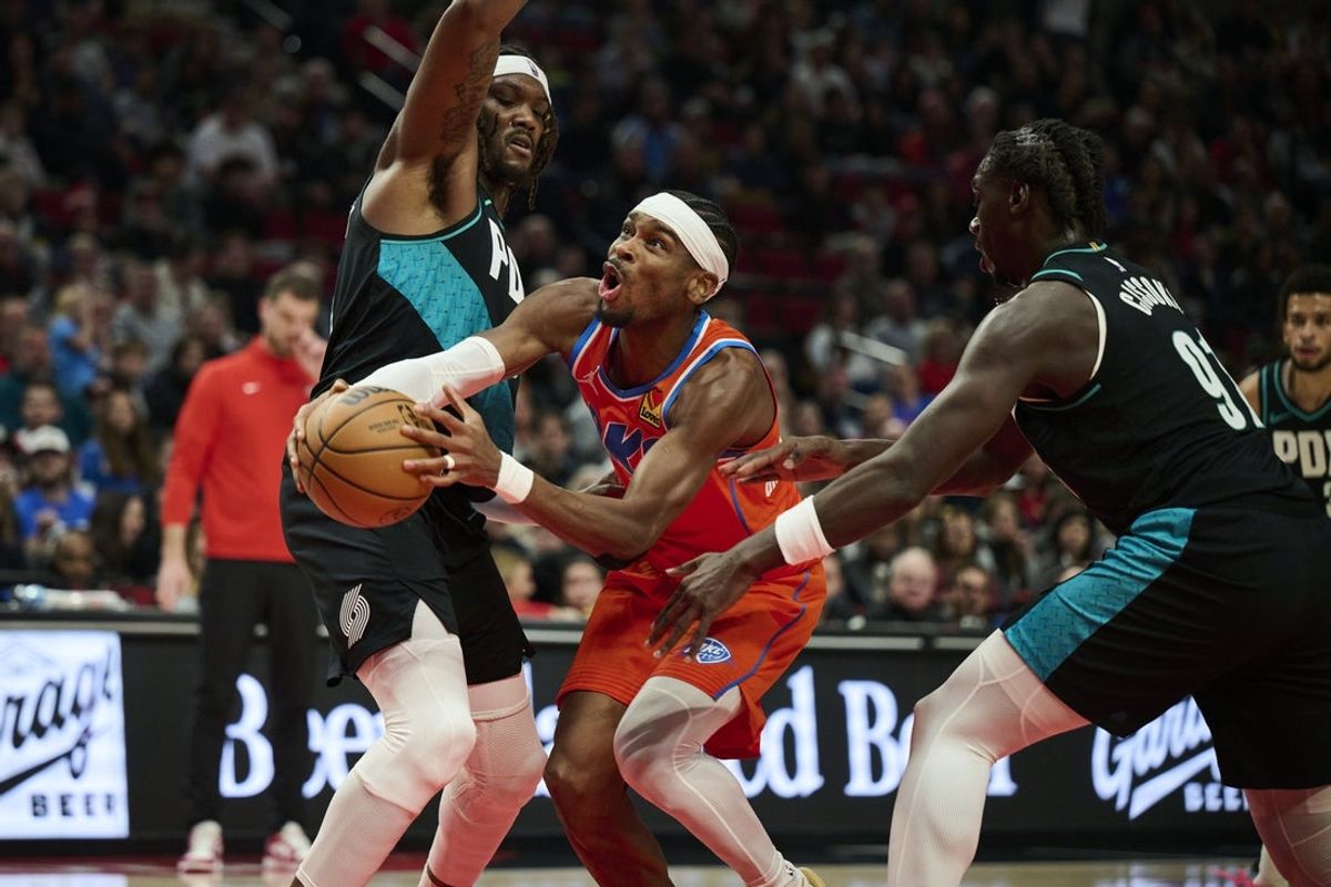 Nov 30, 2025; Portland, Oregon, USA; Oklahoma City Thunder guard Shai Gilgeous-Alexander (2) drives to the basket during the first half against Portland Trail Blazers center Robert Williams III (35) at Moda Center. Mandatory Credit: Troy Wayrynen-Imagn Images