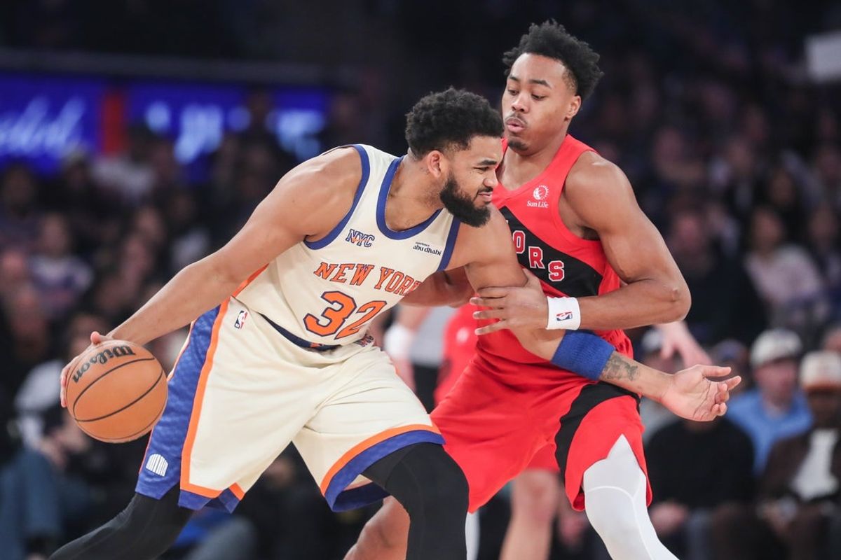 Nov 30, 2025; New York, New York, USA;  New York Knicks center Karl-Anthony Towns (32) looks to post up against Toronto Raptors forward Scottie Barnes (4) in the first quarter at Madison Square Garden. Mandatory Credit: Wendell Cruz-Imagn Images