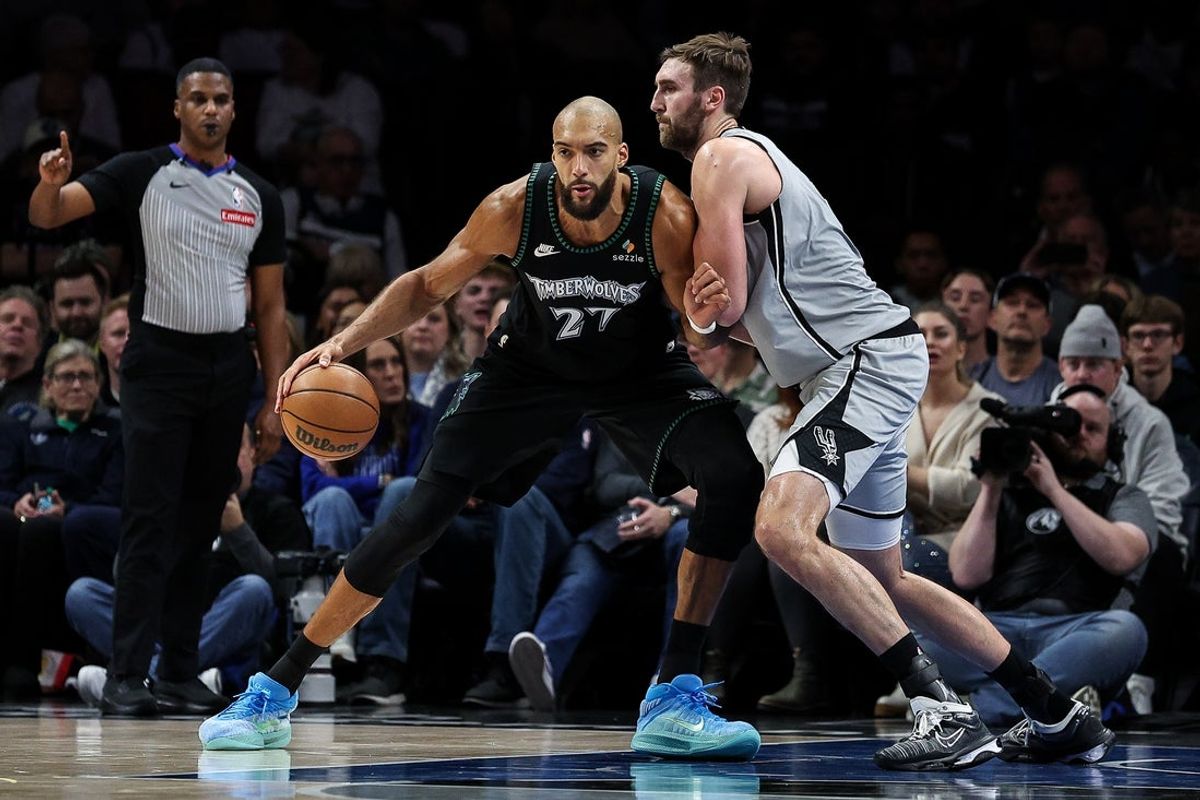Nov 30, 2025; Minneapolis, Minnesota, USA; Minnesota Timberwolves center Rudy Gobert (27) dribbles as San Antonio Spurs center Luke Kornet (7) defends during the first half at Target Center. Mandatory Credit: Matt Krohn-Imagn Images