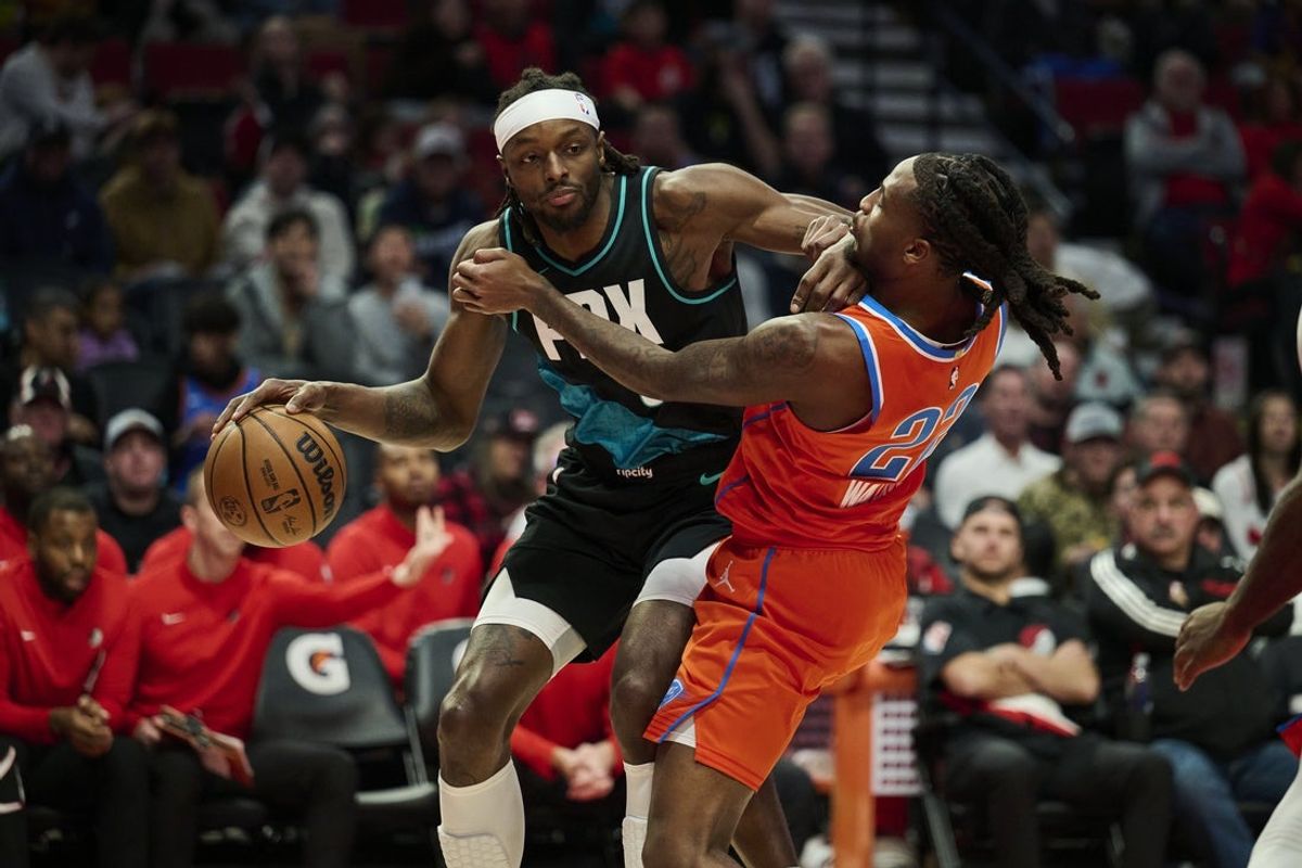 Nov 30, 2025; Portland, Oregon, USA; Portland Trail Blazers forward Jerami Grant (9) drives to the basket during the second half against Oklahoma City Thunder guard Cason Wallace (22) at Moda Center. Mandatory Credit: Troy Wayrynen-Imagn Images