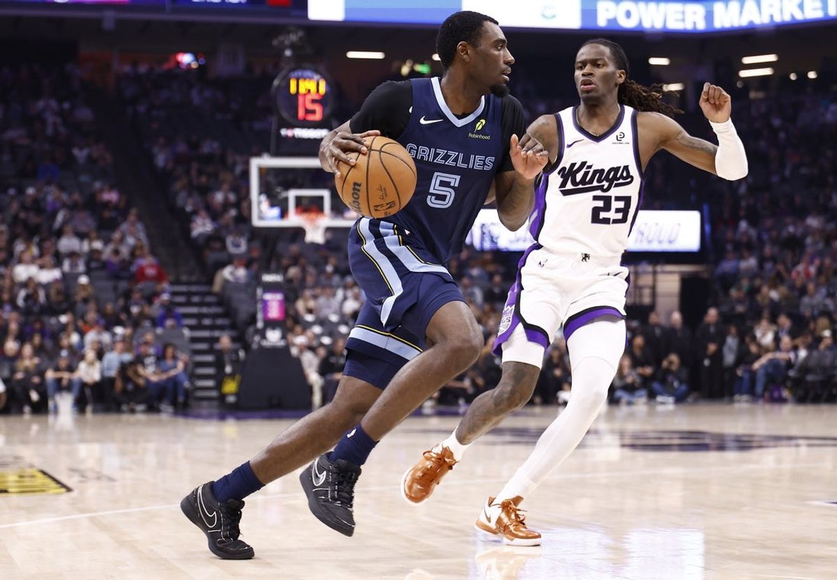 Nov 30, 2025; Sacramento, California, USA; Memphis Grizzlies guard Vince Williams Jr. (5) drives in against Sacramento Kings guard Keon Ellis (23) during the second quarter at Golden 1 Center. Mandatory Credit: Kelley L Cox-Imagn Images