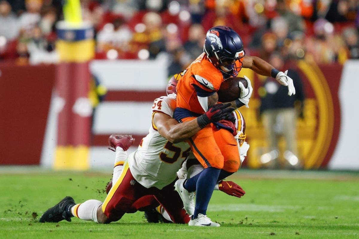 Nov 30, 2025; Landover, Maryland, USA; Washington Commanders linebacker Bobby Wagner (54) tackles Denver Broncos running back RJ Harvey (12) in the second quarter of the game at Northwest Stadium. Mandatory Credit: Peter Casey-Imagn Images