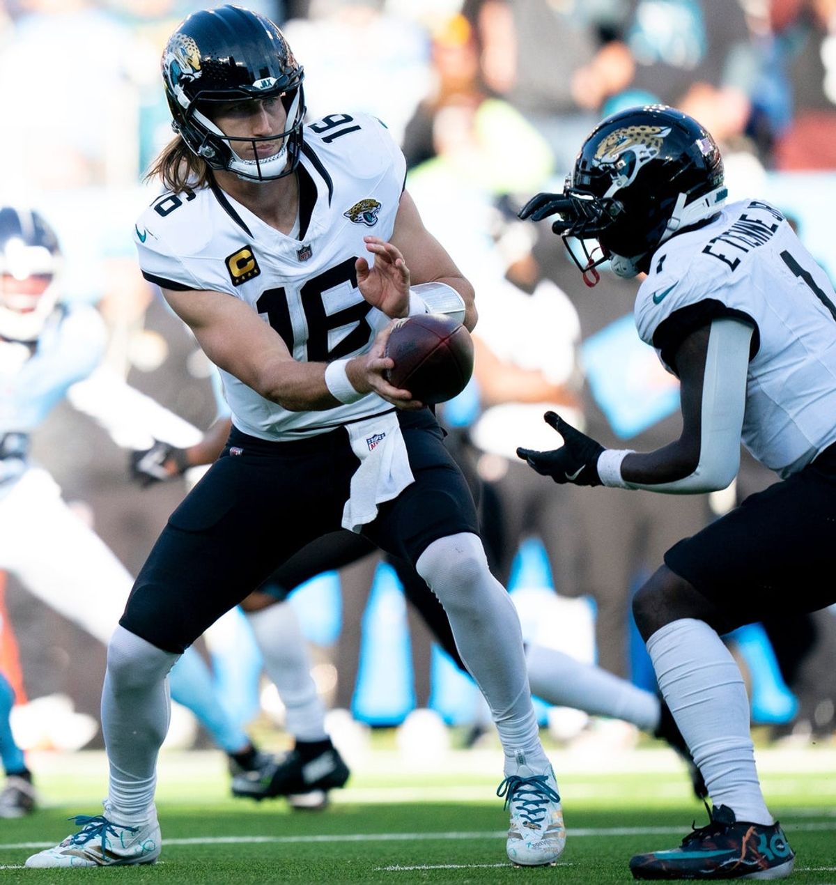 Jacksonville quarterback Trevor Lawrence (16) hands off to running back Travis Etienne Jr. (1) during their game against Tennessee at Nissan Stadium Sunday, Nov. 30, 2025.