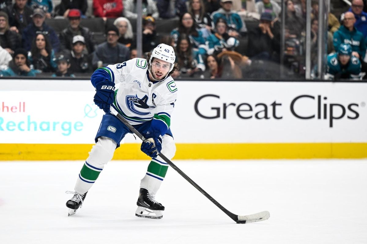Nov 28, 2025; San Jose, California, USA; Vancouver Canucks defenseman Quinn Hughes (43) controls the puck against the San Jose Sharks in the third period at SAP Center at San Jose. Mandatory Credit: Eakin Howard-Imagn Images