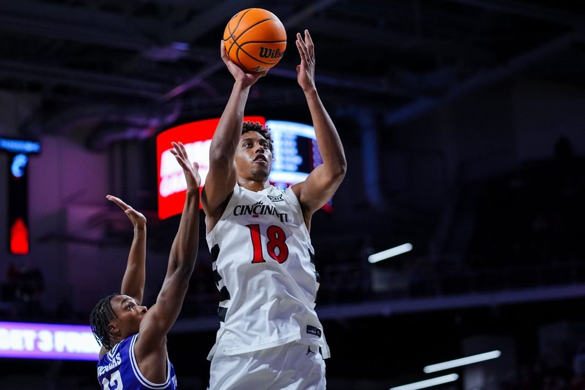 Dec 1, 2025; Cincinnati, Ohio, USA;  Cincinnati Bearcats forward Baba Miller (18) drives to the basket against Tarleton State Texans guard Kade Douglas (13) in the first half at Fifth Third Arena. Mandatory Credit: Aaron Doster-Imagn Images