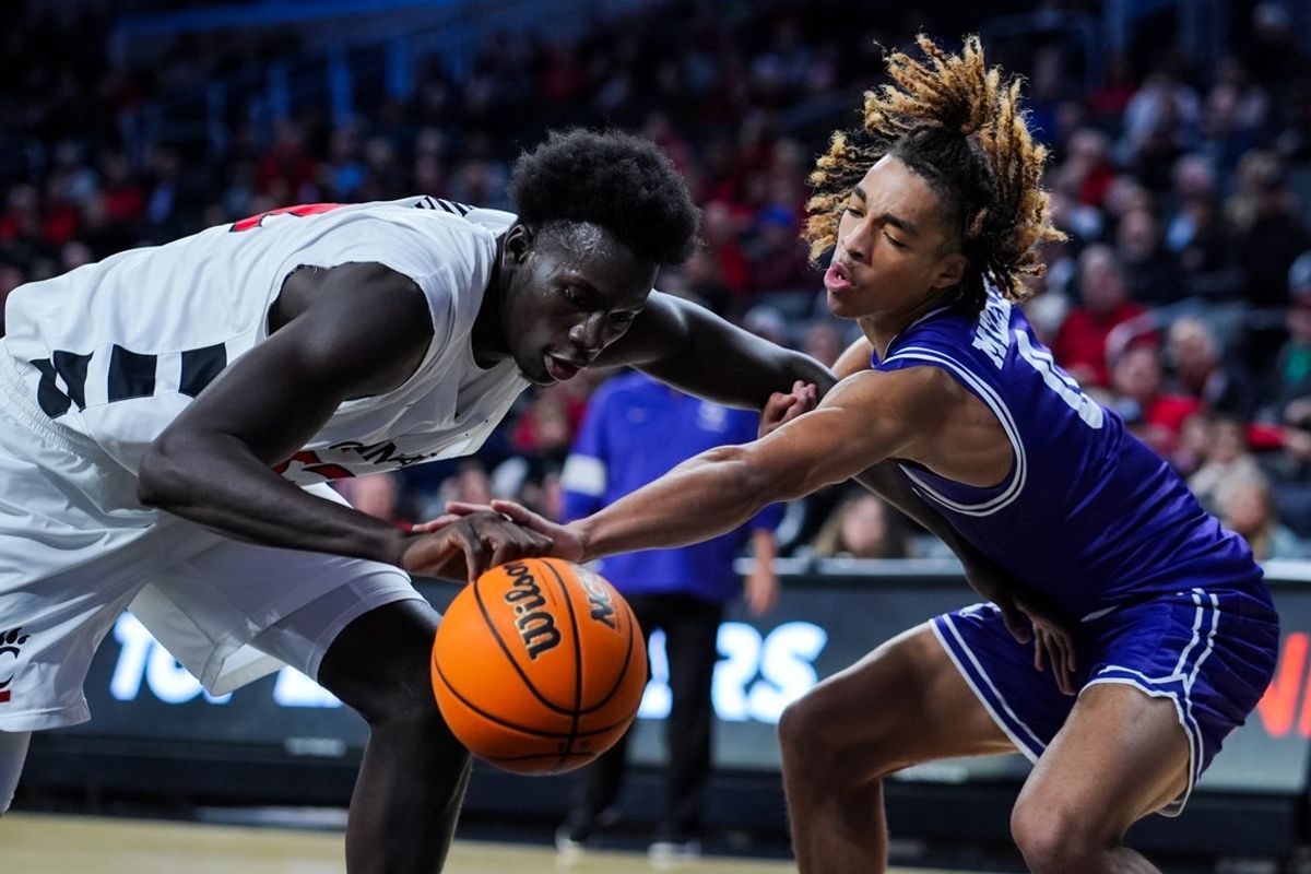Dec 1, 2025; Cincinnati, Ohio, USA;  Cincinnati Bearcats center Moustapha Thiam (52) battles for the loose ball against Tarleton State Texans guard Jordan Mizell (0) in the first half at Fifth Third Arena. Mandatory Credit: Aaron Doster-Imagn Images