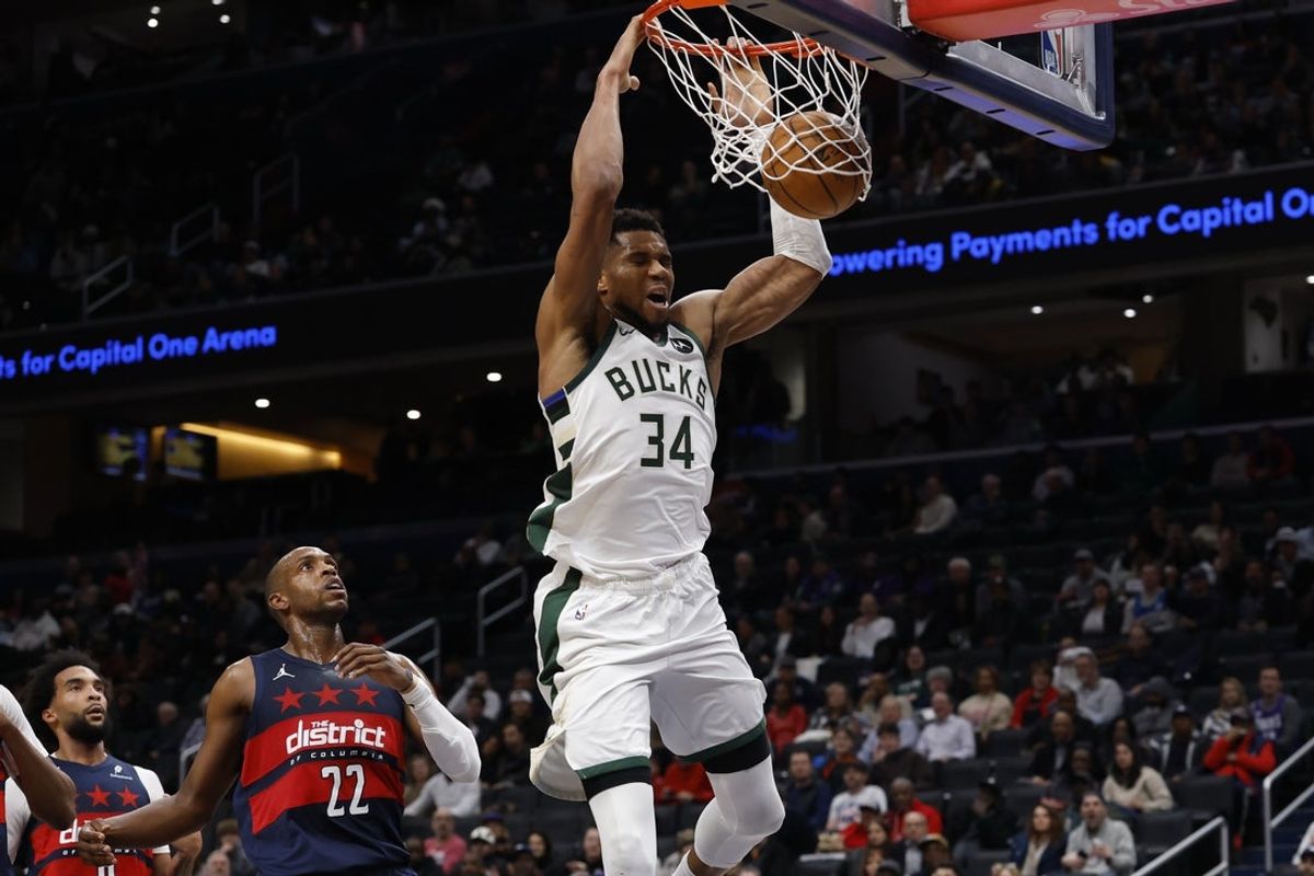 Dec 1, 2025; Washington, District of Columbia, USA; Milwaukee Bucks forward Giannis Antetokounmpo (34) dunks the ball as Washington Wizards forward Khris Middleton (22) looks on in the second quarter at Capital One Arena. Mandatory Credit: Geoff Burke-Imagn Images