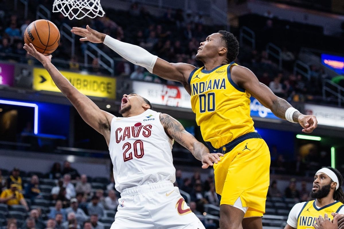 Dec 1, 2025; Indianapolis, Indiana, USA; Cleveland Cavaliers guard Jaylon Tyson (20)  shoots the ball while  Indiana Pacers guard Bennedict Mathurin (00) defends in the first half at Gainbridge Fieldhouse. Mandatory Credit: Trevor Ruszkowski-Imagn Images