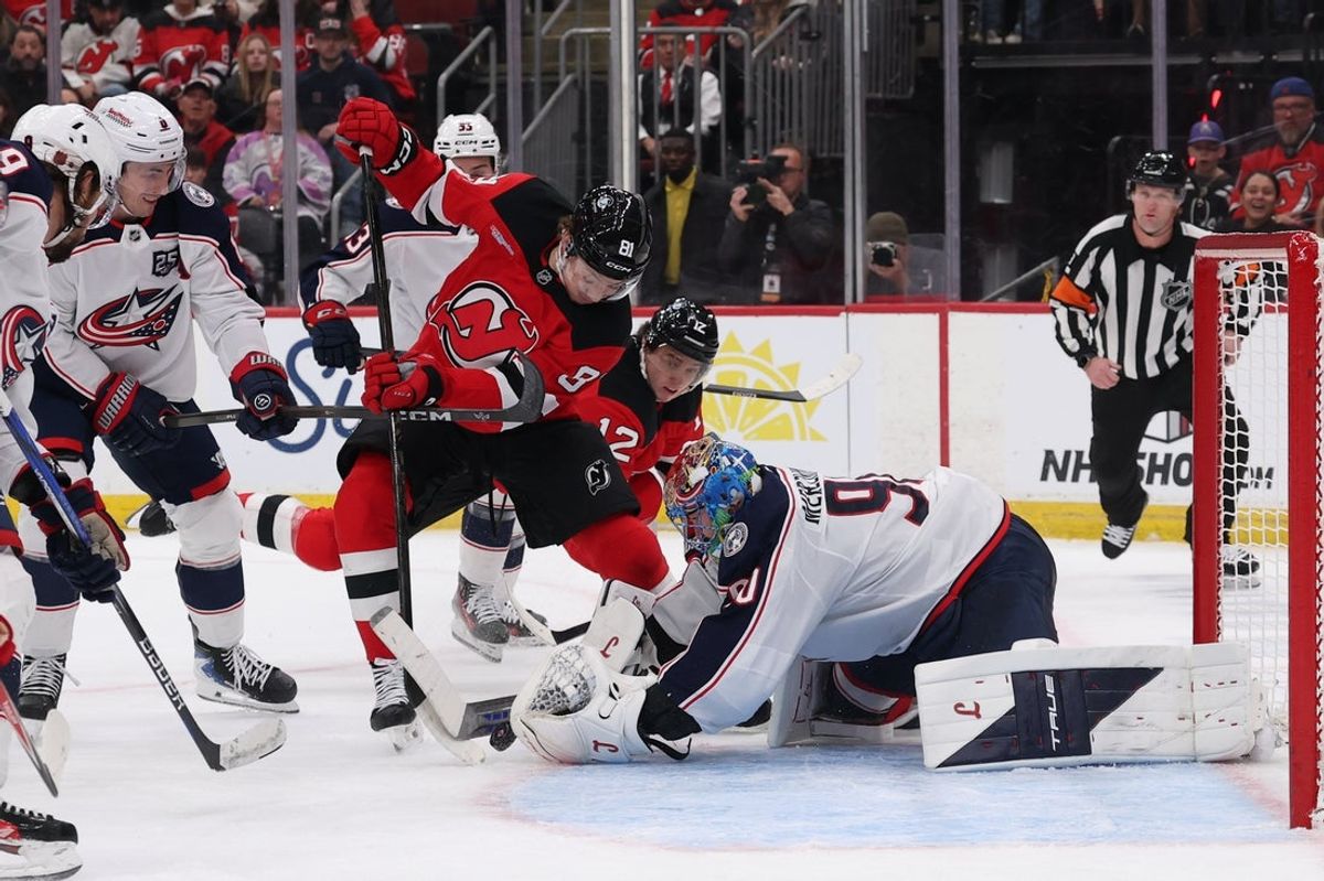 Dec 1, 2025; Newark, New Jersey, USA; Columbus Blue Jackets goaltender Elvis Merzlikins (90) makes a save on New Jersey Devils right wing Arseny Gritsyuk (81) during the second period at Prudential Center. Mandatory Credit: Ed Mulholland-Imagn Images