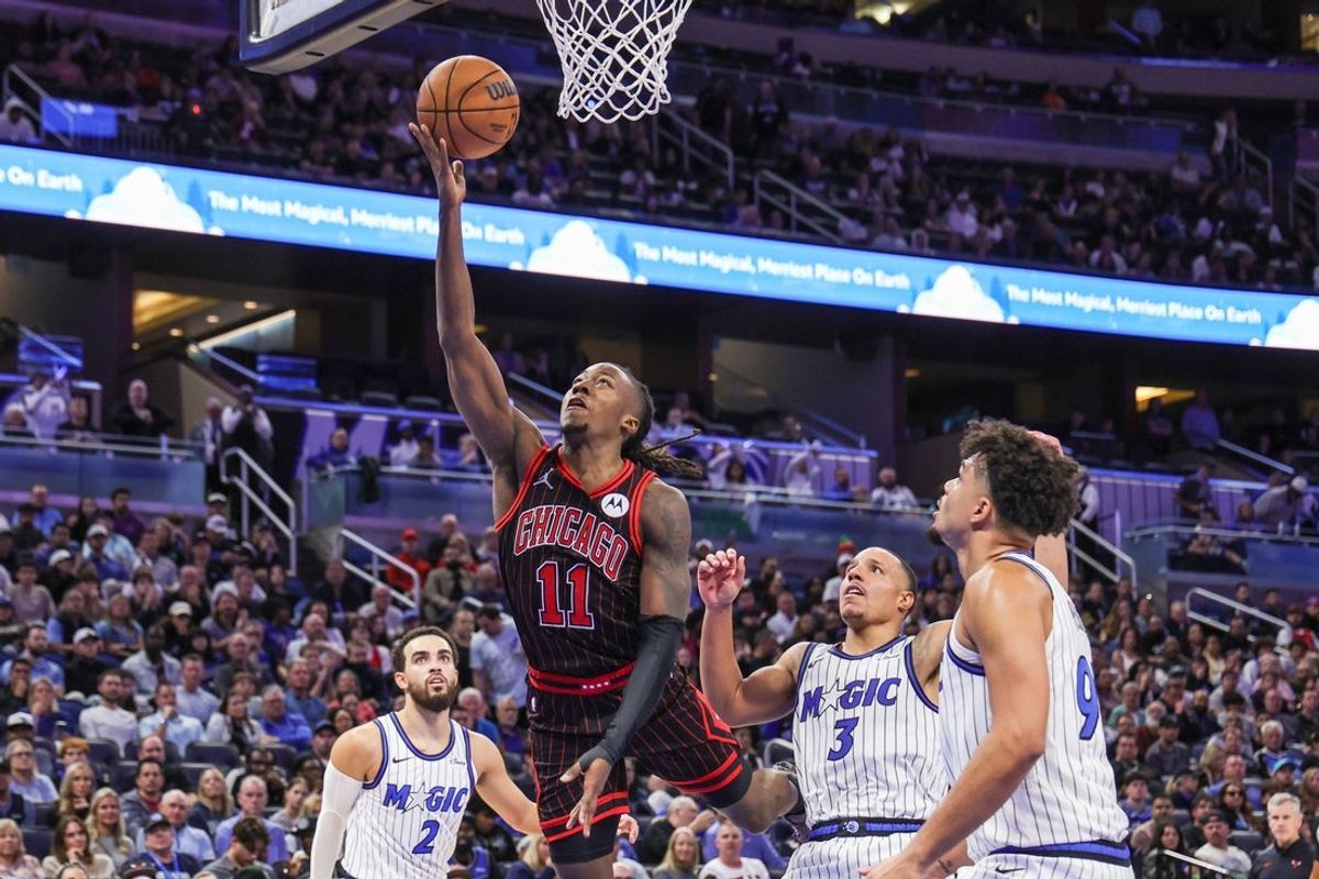 Dec 1, 2025; Orlando, Florida, USA; Chicago Bulls guard Ayo Dosunmu (11) goes to the basket against Orlando Magic guard Desmond Bane (3) during the second half at Kia Center. Mandatory Credit: Mike Watters-Imagn Images