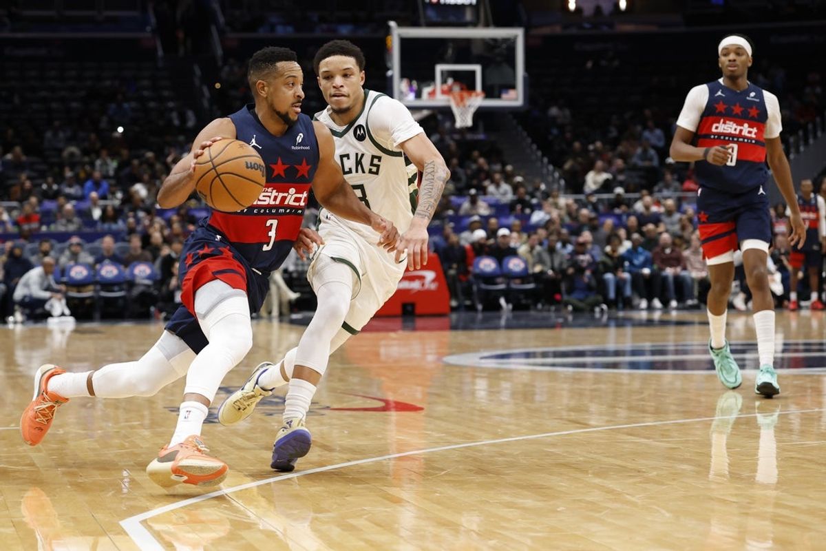 Dec 1, 2025; Washington, District of Columbia, USA; Washington Wizards guard CJ McCollum (3) drives to the basket as Milwaukee Bucks guard Ryan Rollins (13) defends in the second half at Capital One Arena. Mandatory Credit: Geoff Burke-Imagn Images