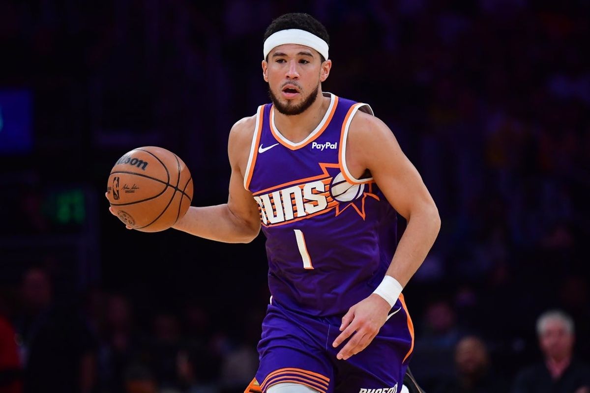 Dec 1, 2025; Los Angeles, California, USA; Phoenix Suns guard Devin Booker (1) moves the ball up court against the Los Angeles Lakers during the first half at Crypto.com Arena. Mandatory Credit: Gary A. Vasquez-Imagn Images