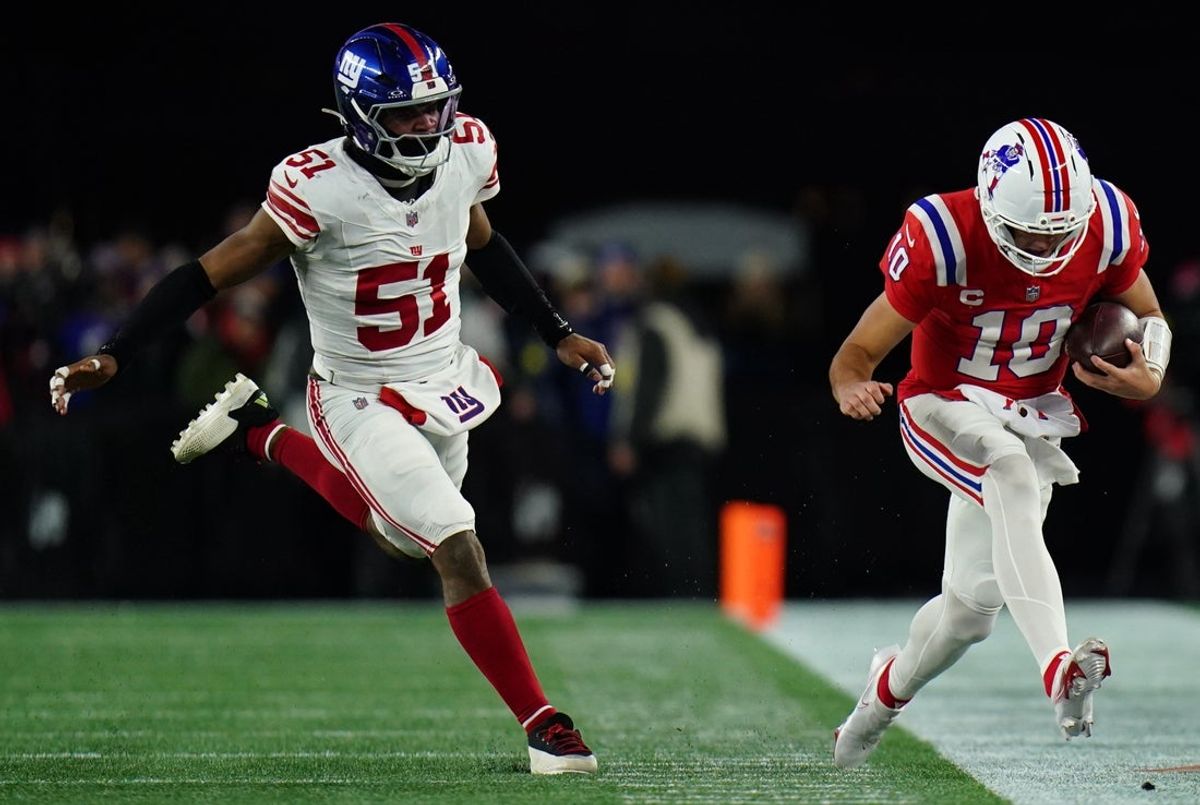 Dec 1, 2025; Foxborough, Massachusetts, USA; New England Patriots quarterback Drake Maye (10) runs the ball against New York Giants linebacker Abdul Carter (51) during the third quarter at Gillette Stadium. Mandatory Credit: David Butler II-Imagn Images