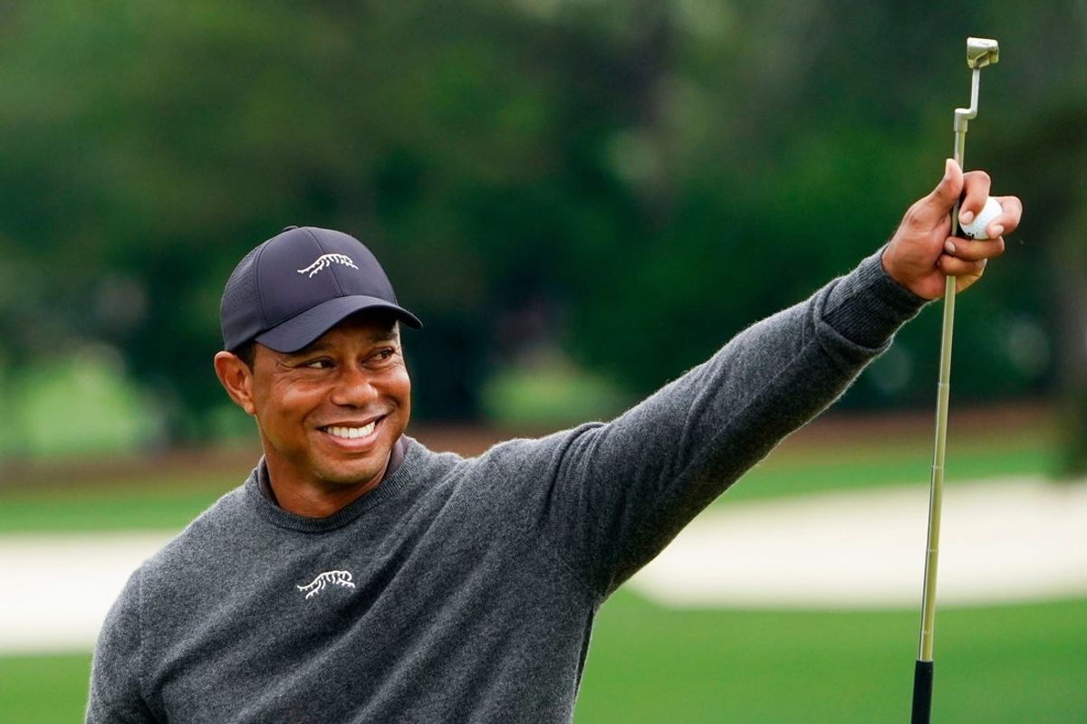 Tiger Woods gives a thumbs up to the crowd on the no. 9 green during a practice round for the Masters Tournament golf tournament at Augusta National Golf Club in 2024.