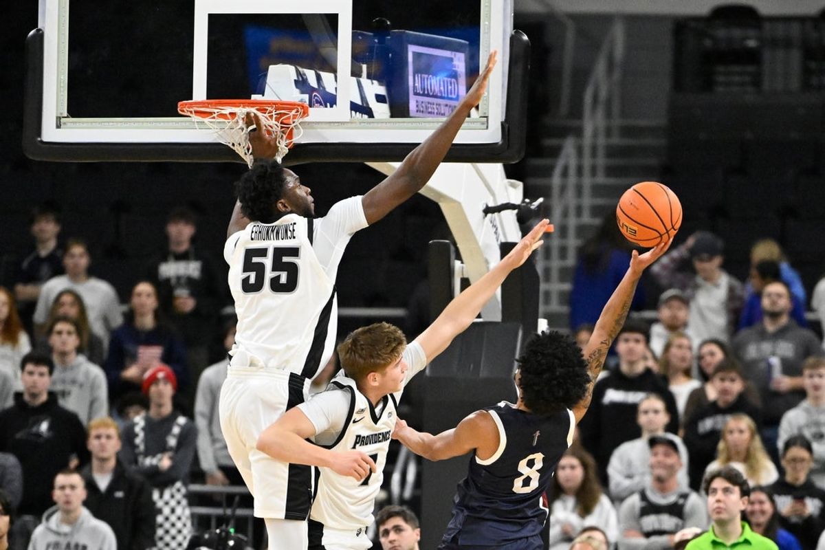 Dec 2, 2025; Providence, Rhode Island, USA; Fairleigh Dickinson Knights guard Noah Melson (8) shoots against the defense of Providence Friars forward Oswin Erhunmwunse (55) during the first half at Amica Mutual Pavilion. Mandatory Credit: Eric Canha-Imagn Images