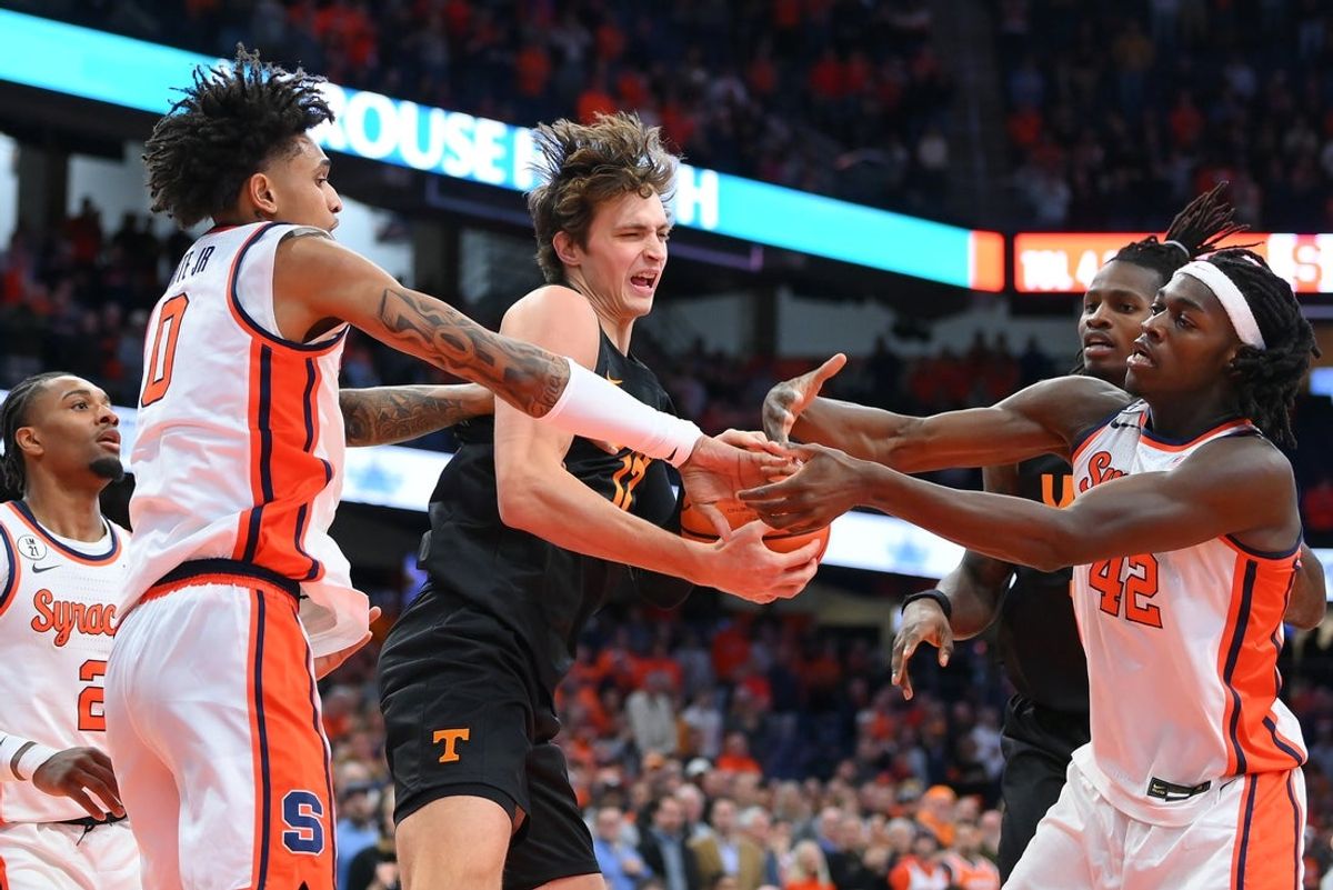 Dec 2, 2025; Syracuse, New York, USA; Tennessee Volunteers forward Cade Phillips (center) battles with Syracuse Orange forwards Sadiq White Jr. (left) and William Kyle III (right) during the first half at the JMA Wireless Dome. Mandatory Credit: Rich Barnes-Imagn Images