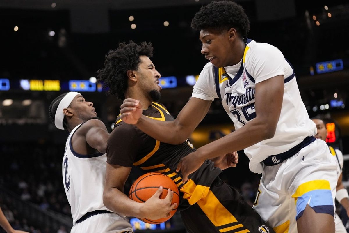 Dec 2, 2025; Milwaukee, Wisconsin, USA;  Valparaiso Beacons forward JT Pettigrew (7) tries to keep the ball away from Marquette Golden Eagles forward Michael Phillips II (35) during the first half at Fiserv Forum. Mandatory Credit: Jeff Hanisch-Imagn Images
