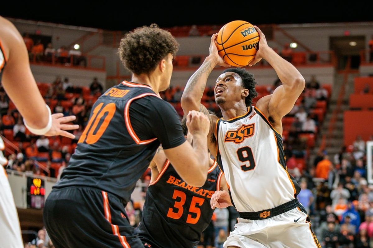 Dec 2, 2025; Stillwater, Oklahoma, USA; Oklahoma State Cowboys guard Anthony Roy (9) drives to the basket around Sam Houston Bearkats forward Jaxson Ford (10) during the first half at Gallagher-Iba Arena. Mandatory Credit: William Purnell-Imagn Images