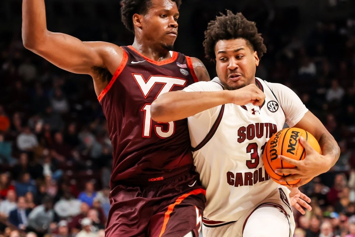 Dec 2, 2025; Columbia, South Carolina, USA; South Carolina Gamecocks forward Elijah Strong (31) drives around Virginia Tech Hokies forward Amani Hansberry (13) in the first half at Colonial Life Arena. Mandatory Credit: Jeff Blake-Imagn Images