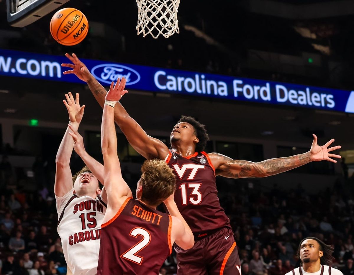 Dec 2, 2025; Columbia, South Carolina, USA; Virginia Tech Hokies forward Amani Hansberry (13) grabs a rebound over South Carolina Gamecocks guard Eli Ellis (15) in the first half at Colonial Life Arena. Mandatory Credit: Jeff Blake-Imagn Images