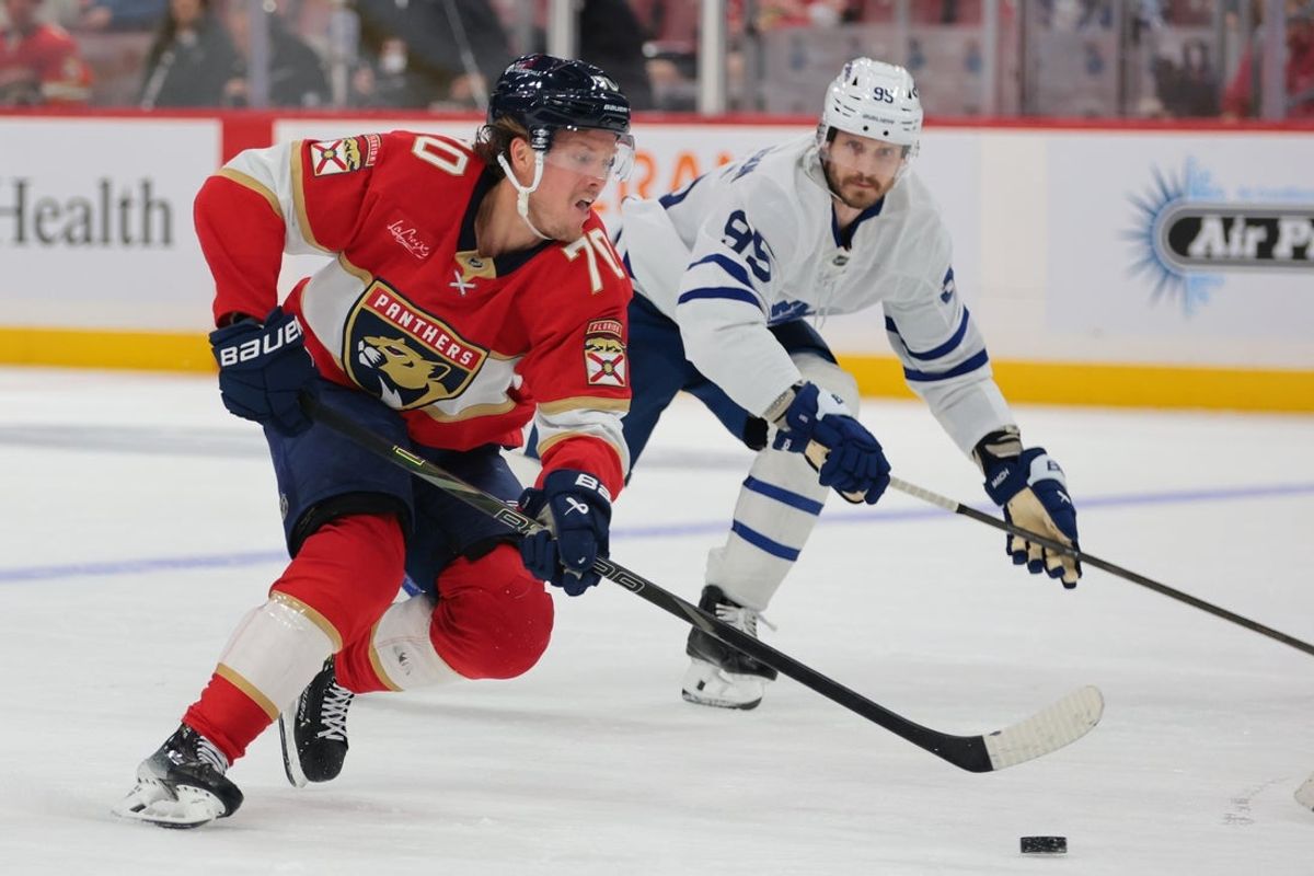 Dec 2, 2025; Sunrise, Florida, USA; Florida Panthers center Jesper Boqvist (70) moves the puck against Toronto Maple Leafs defenseman Oliver Ekman-Larsson (95) during the third period at Amerant Bank Arena. Mandatory Credit: Sam Navarro-Imagn Images