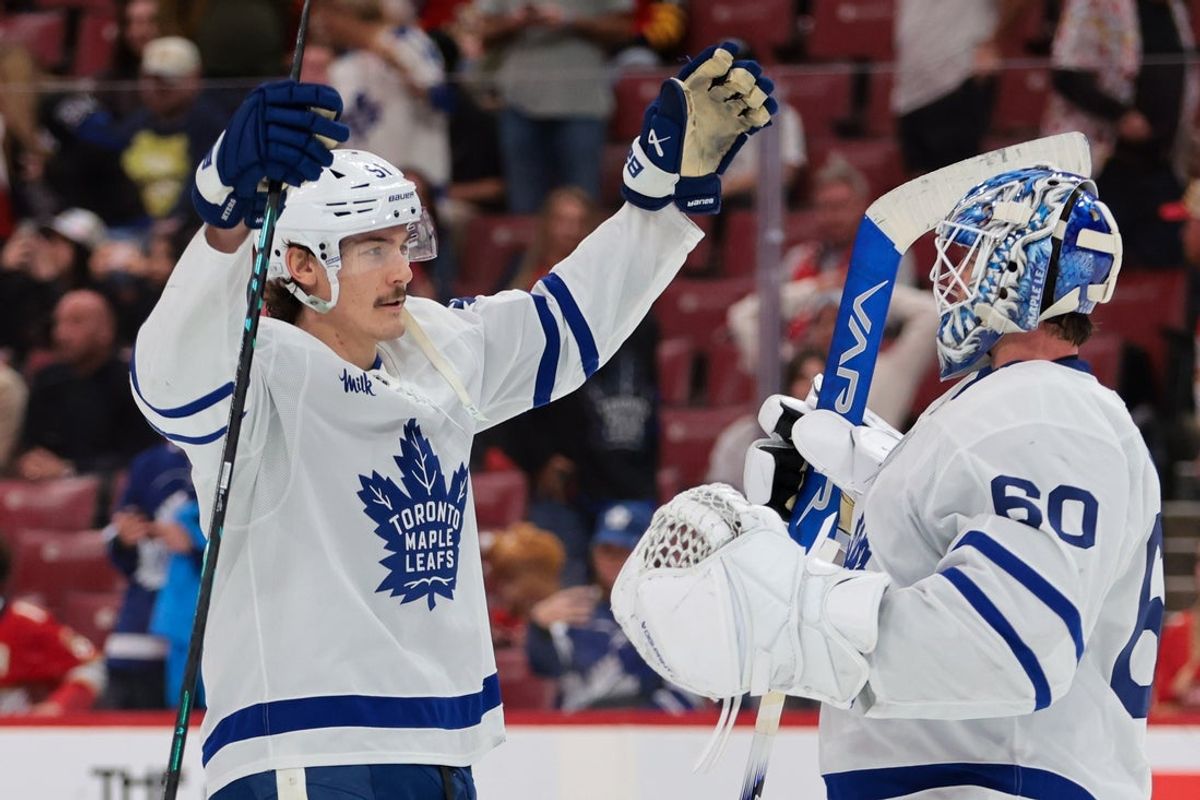Dec 2, 2025; Sunrise, Florida, USA; Toronto Maple Leafs defenseman Philippe Myers (51) celebrates with goaltender Joseph Woll (60) after the game against the Florida Panthers at Amerant Bank Arena. Mandatory Credit: Sam Navarro-Imagn Images