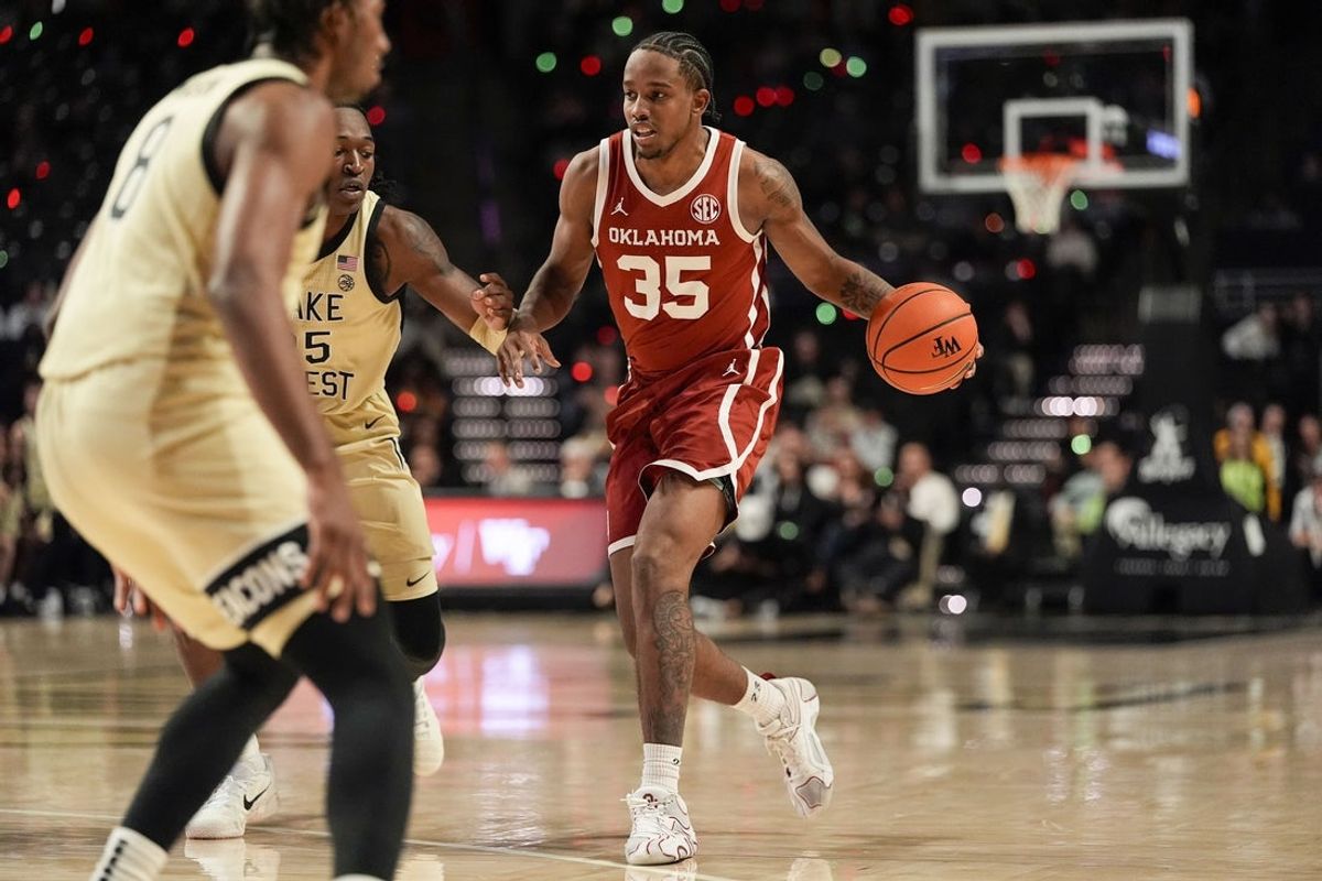 Dec 2, 2025; Winston-Salem, North Carolina, USA; Oklahoma Sooners forward Derrion Reid (35) handles the ball against Wake Forest Demon Deacons forward Tre'Von Spillers (25) during the second half at Lawrence Joel Veterans Memorial Coliseum. Mandatory Credit: Jim Dedmon-Imagn Images
