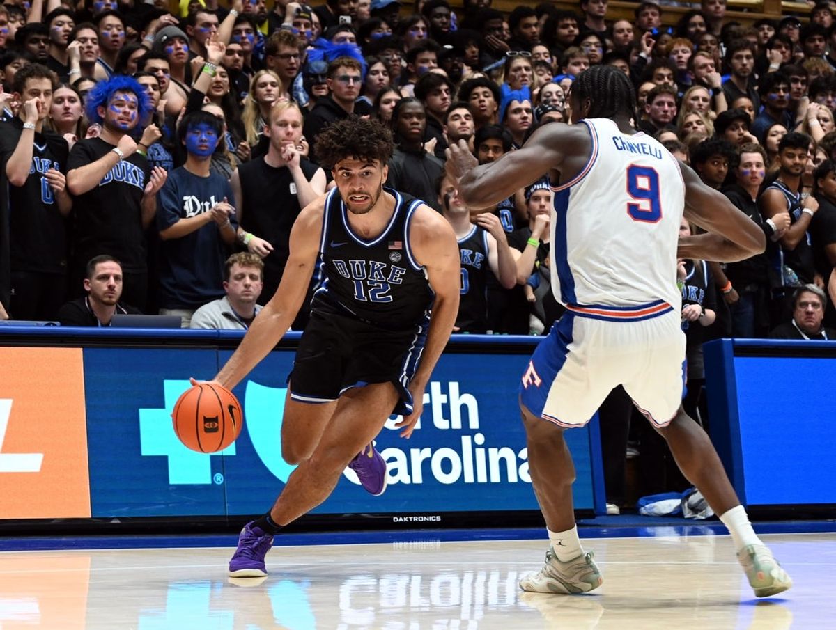 Dec 2, 2025; Durham, North Carolina, USA; Duke Blue Devils forward Cameron Boozer (12) drives to the basket as Florida Gators center Rueben Chinyelu (9) defends during the second half at Cameron Indoor Stadium.  The Blue Devils won 67-66. Mandatory Credit: Rob Kinnan-Imagn Images